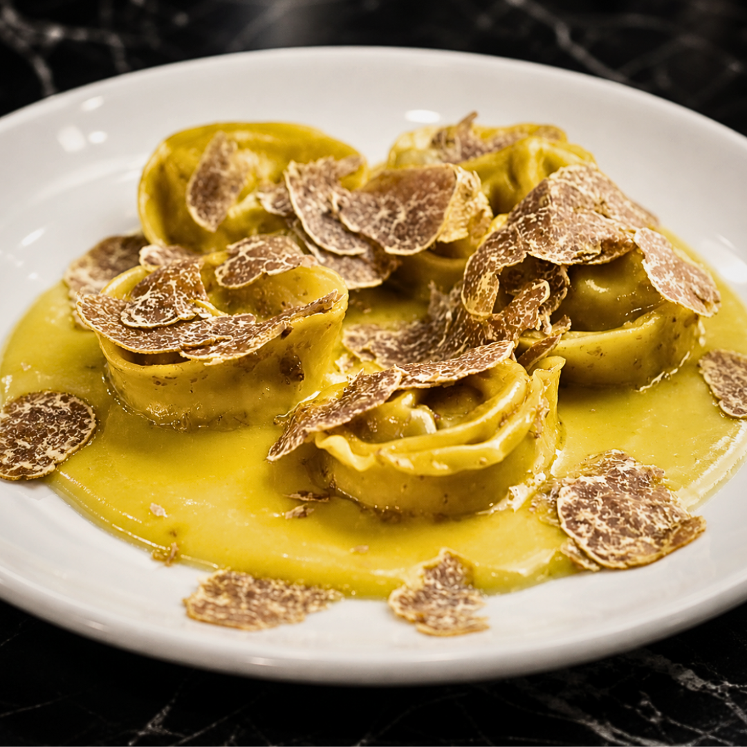 Handmade truffle ravioli filled with black truffle, served with hazelnut brown butter and freshly shaved summer black truffle at Fadiga, Soho, London.