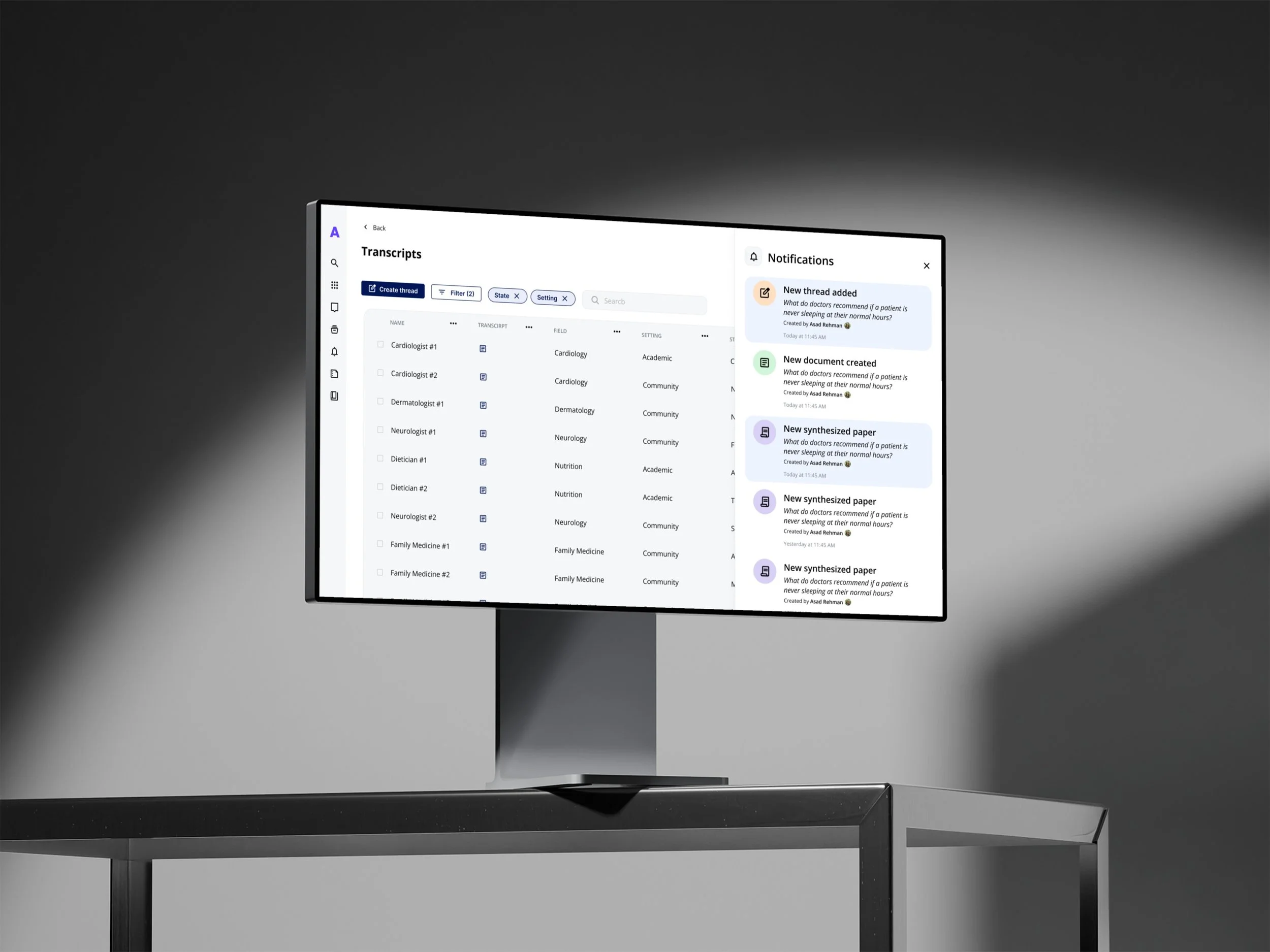 Computer monitor displaying a medical transcription application with a list of doctor names, fields, and settings, and notifications about new documents and synthesized papers.