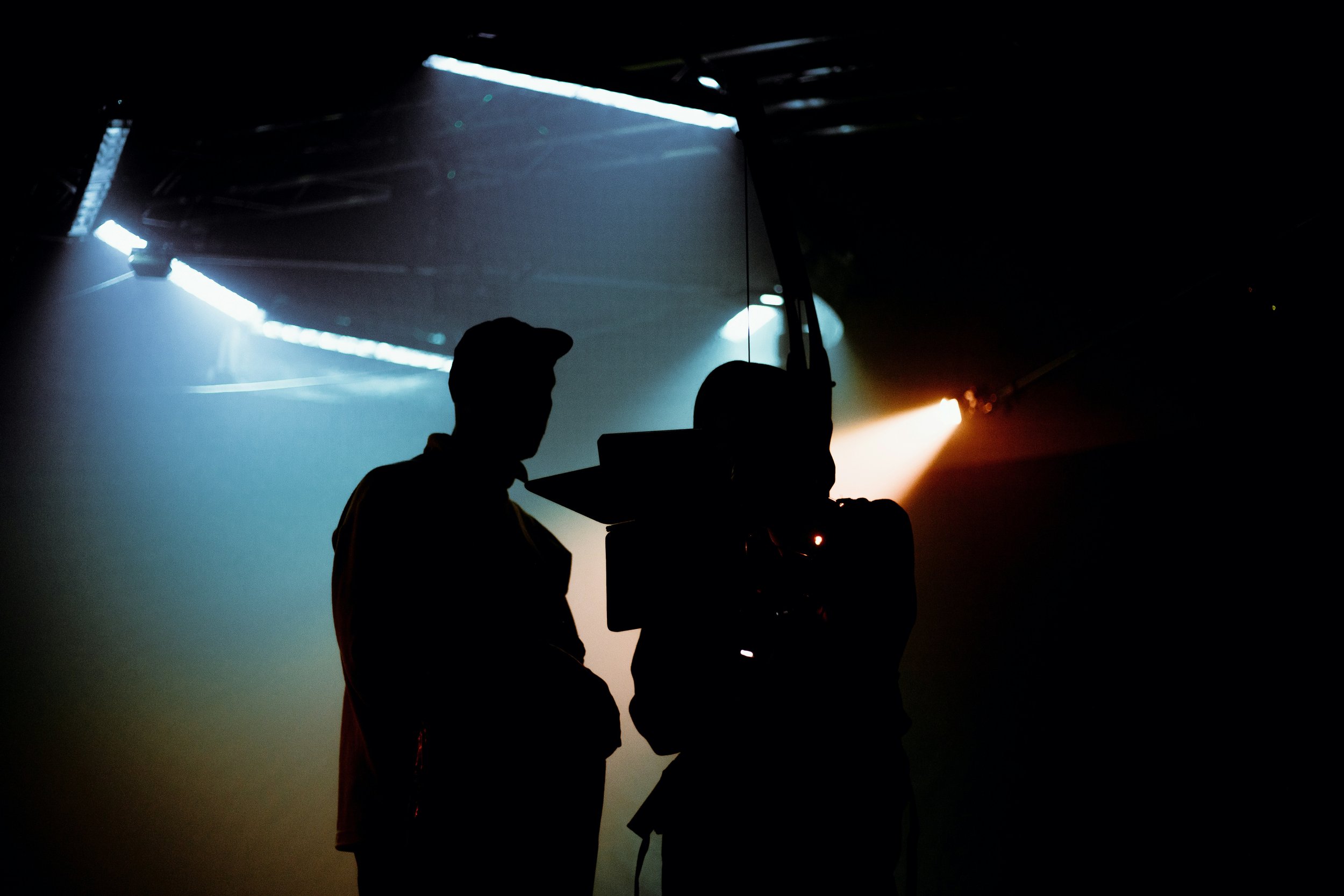 Director behind camera on a filmset.