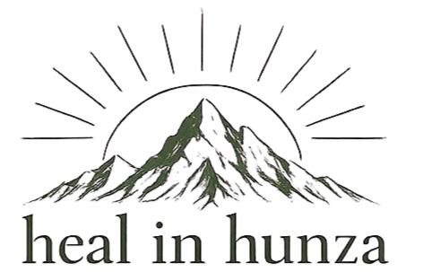 Stylized mountain range with a semi-circle sun behind it and rays extending outward, with the text 'heal in hunza' below.