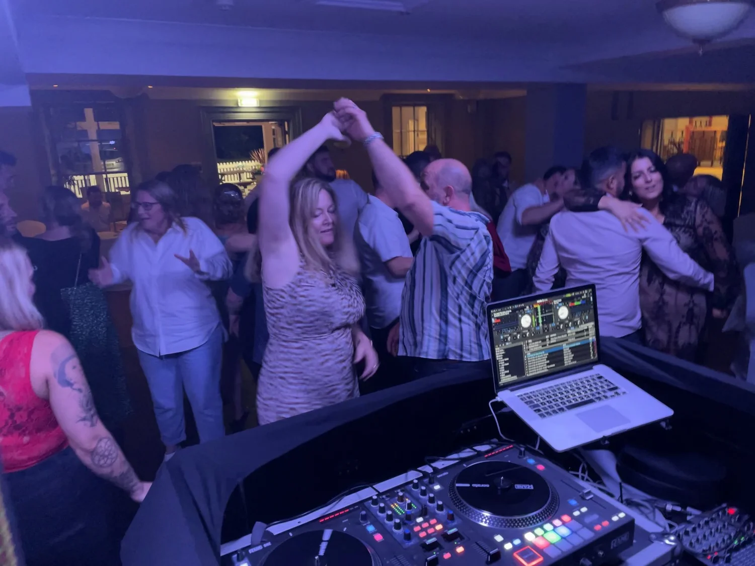 Wedding guests celebrating on the dance floor with Gower DJ