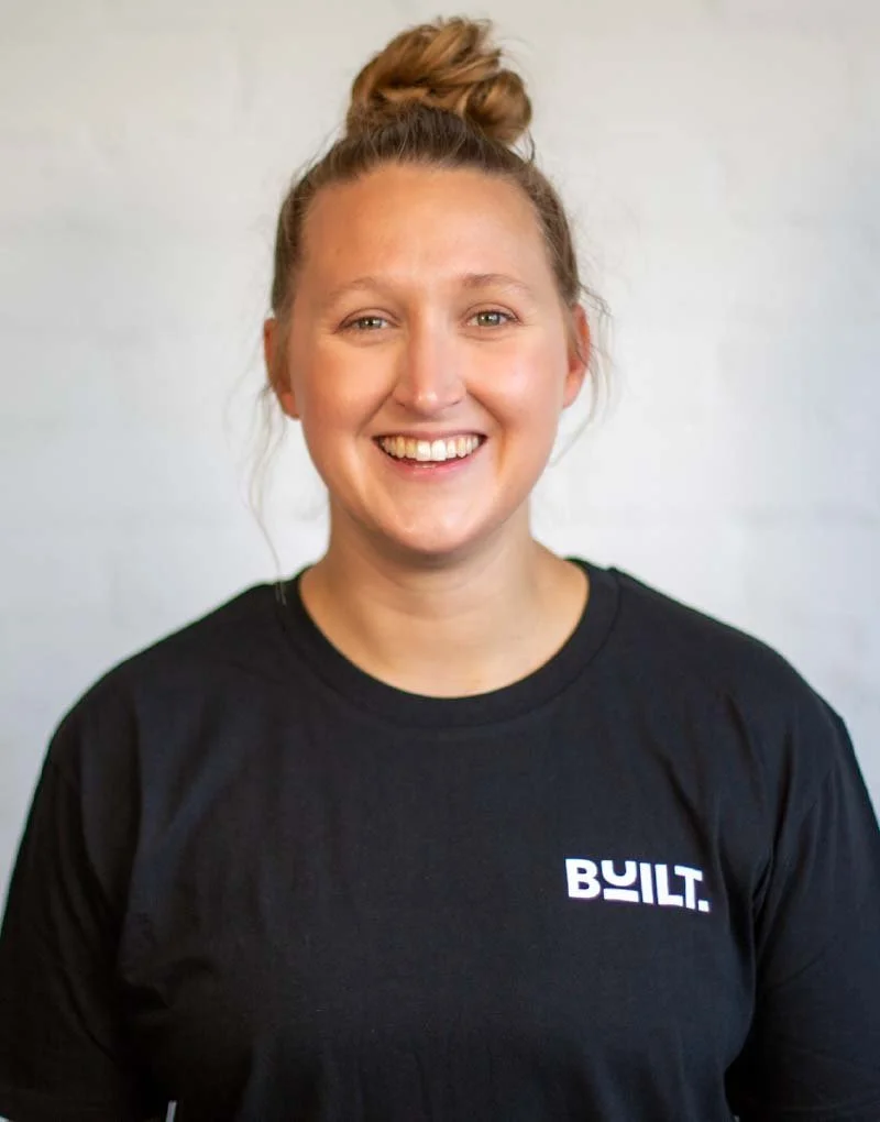 Jasmine, BUILT Training owner and head coach headshot, wearing BUILT branded t-shirt