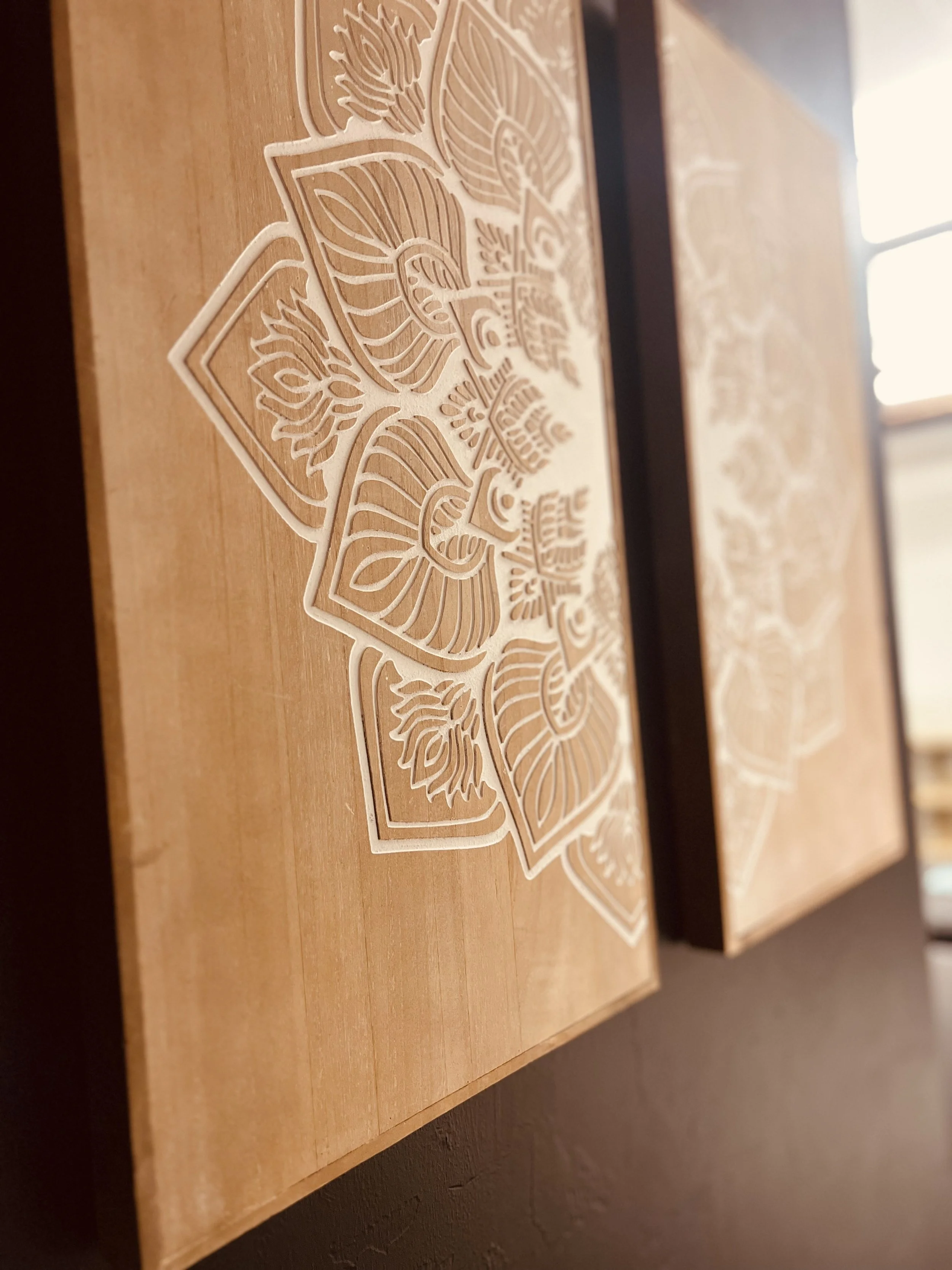 Wooden panels with an engraved mandala design.