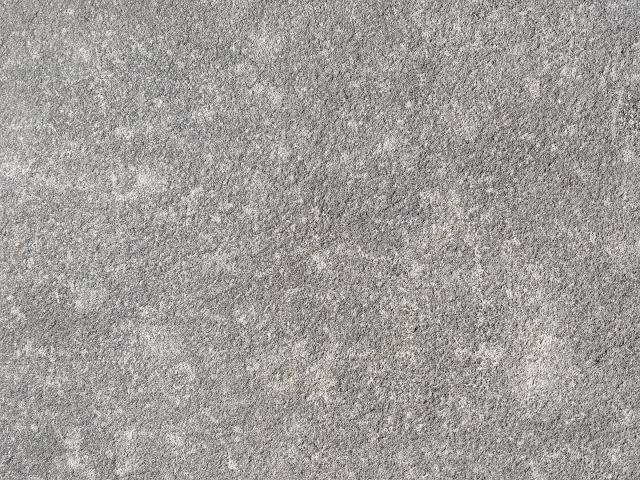 Close-up of a sandy, textured surface of a beach or desert sand.
