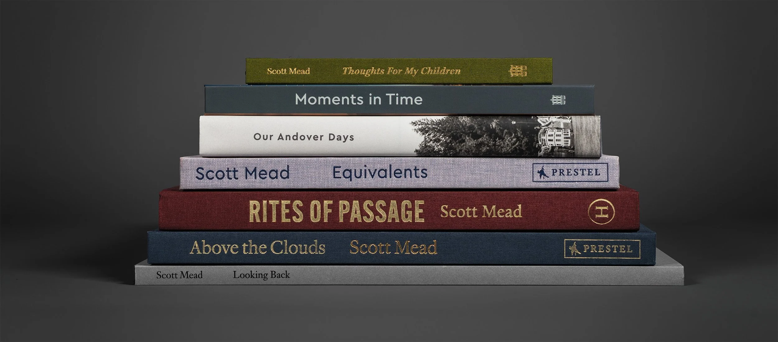 Stack of eight books with different titles and colors on a dark background.