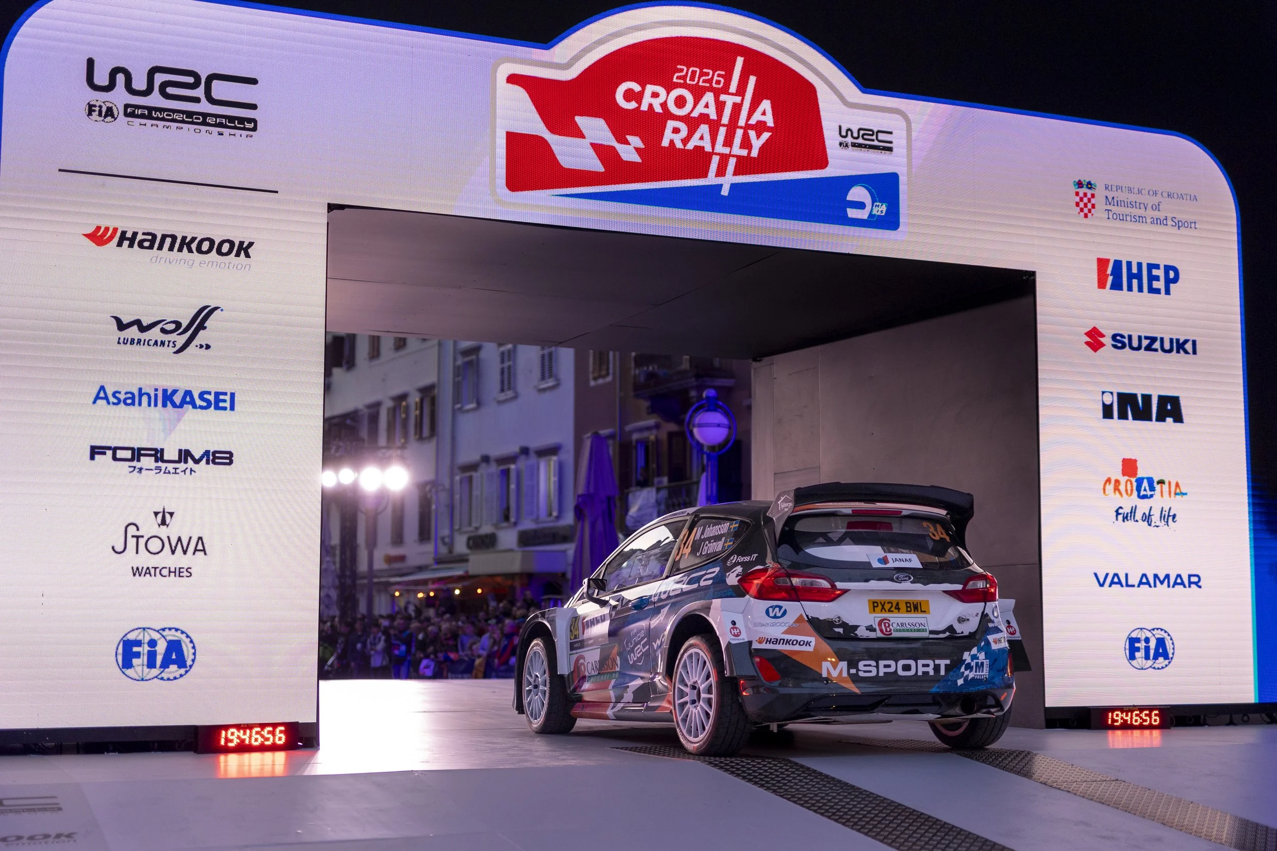 Rally car on a stage at the 2026 Croatia Rally, part of the FIA World Rally Championship, with sponsor banners and a crowd in the background.