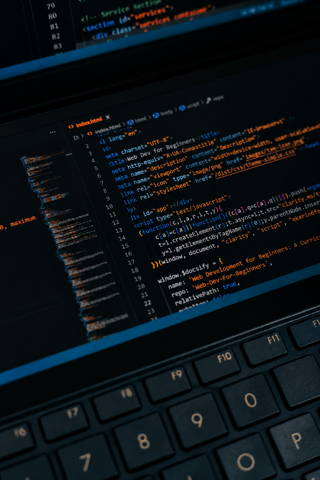 Computer screen displaying HTML and JavaScript code in a code editor with a black background and colorful syntax highlighting.
