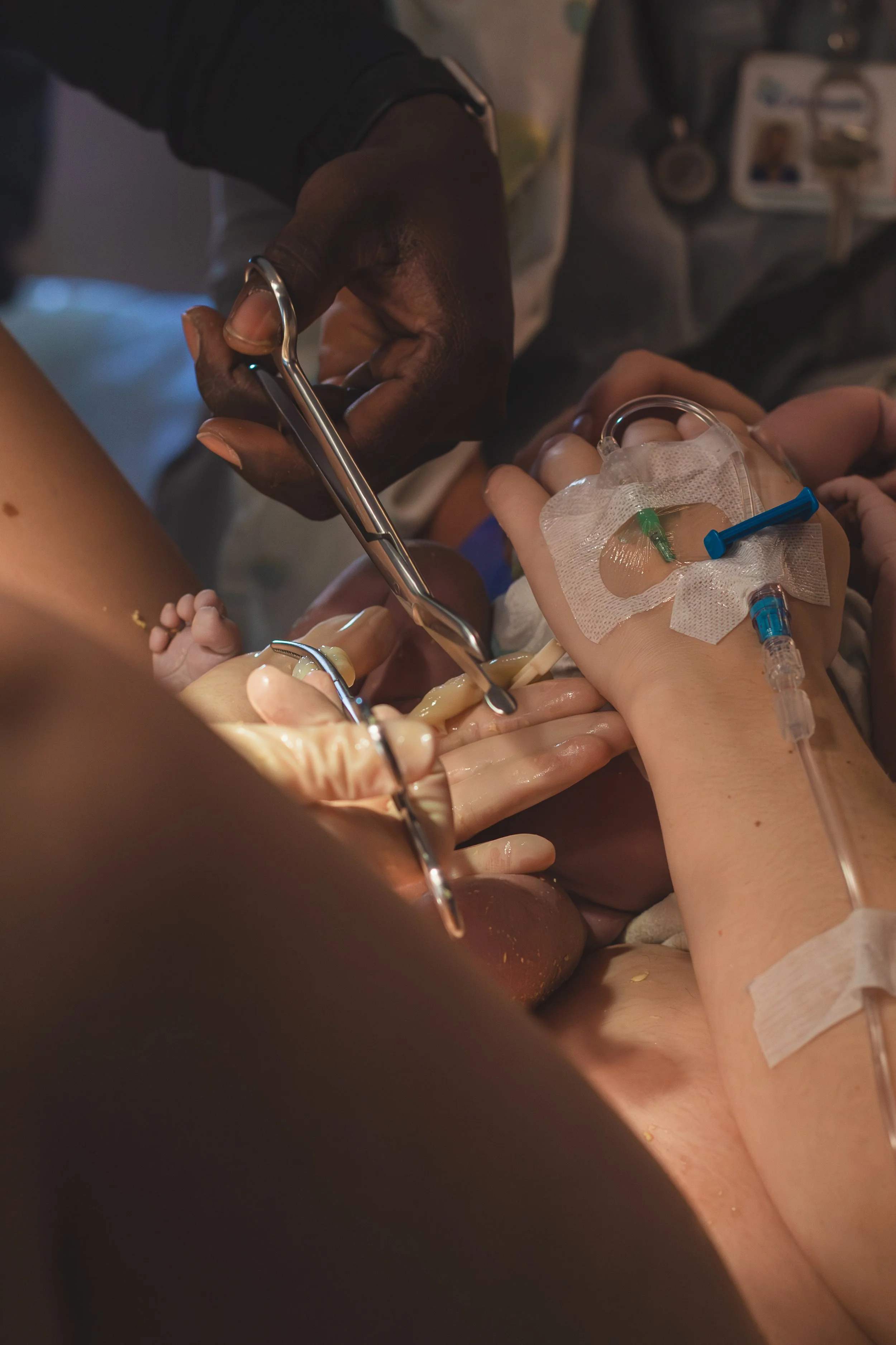 Close-up of a person performing surgery with surgical tools in an operating room, with medical gloves and equipment visible.