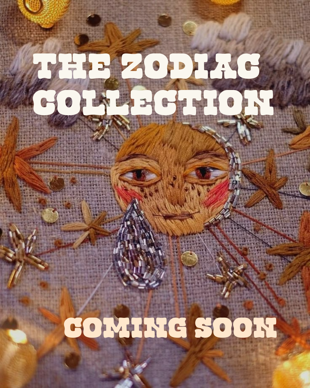 Embroidery artwork of a face with a tear, surrounded by embroidered leaves and beads, with overlaid text 'The Zodiac Collection Coming Soon'.
