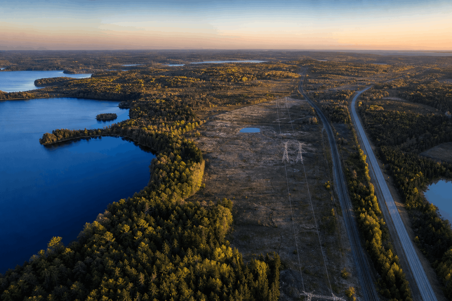 Waterfront Ontario community connected by a bridge with transmission infrastructure beyond