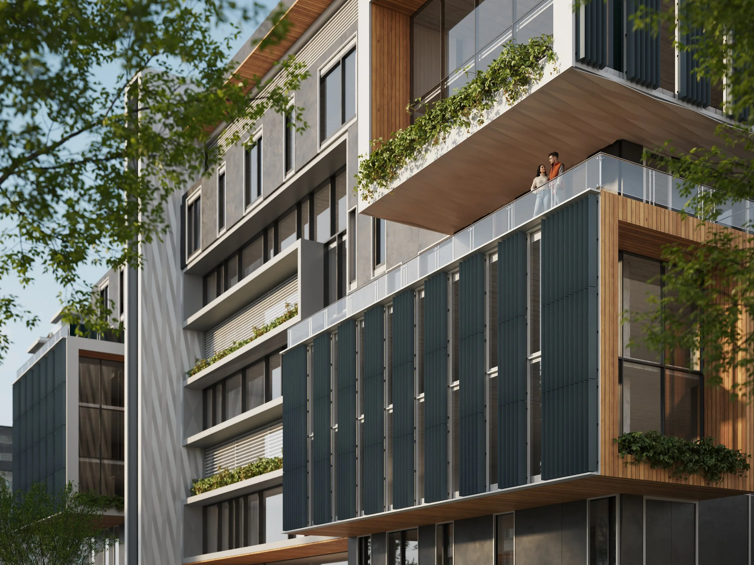 Modern multi-story apartment building with balconies, glass railings, and wooden accents, partially obscured by green tree branches.