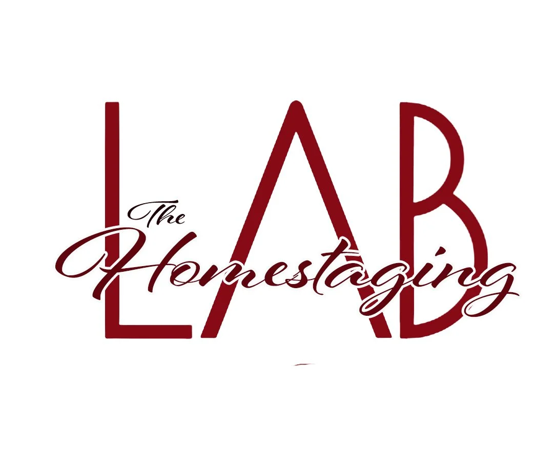 Text logo that reads "The Homesteading LAB" with stylized, large maroon letters 'L', 'A', and 'B' with the words 'The Homesteading' overlaying the letters.