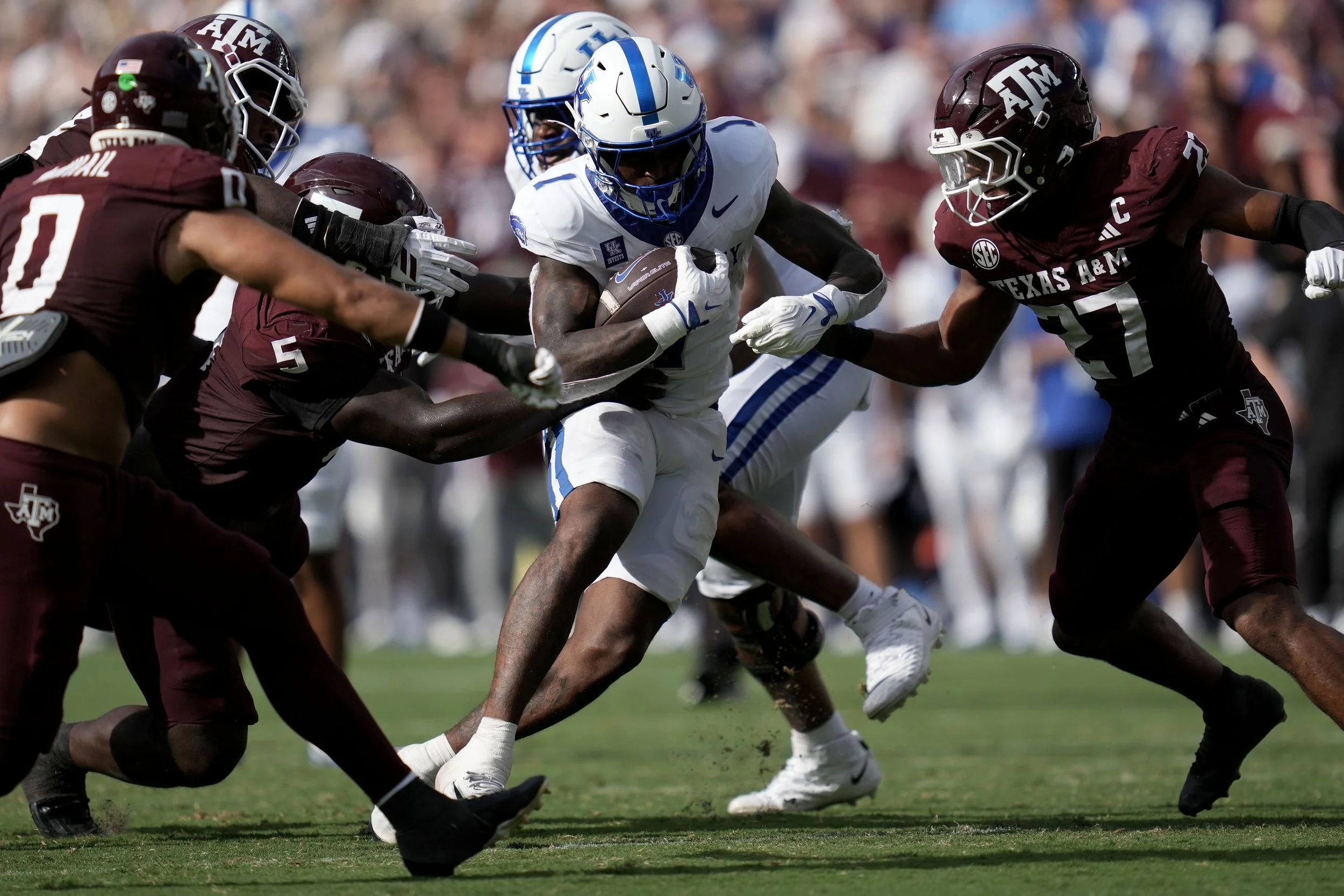 Kentucky running back CJ Baxter Jr. (1) runs through a tackle attempt by Texas A&M defensive tackle DJ Hicks (5) during the third quarter of an NCAA college football game in College Station, Texas, Saturday, Sept. 19, 2026. (AP Photo/Sam Craft)