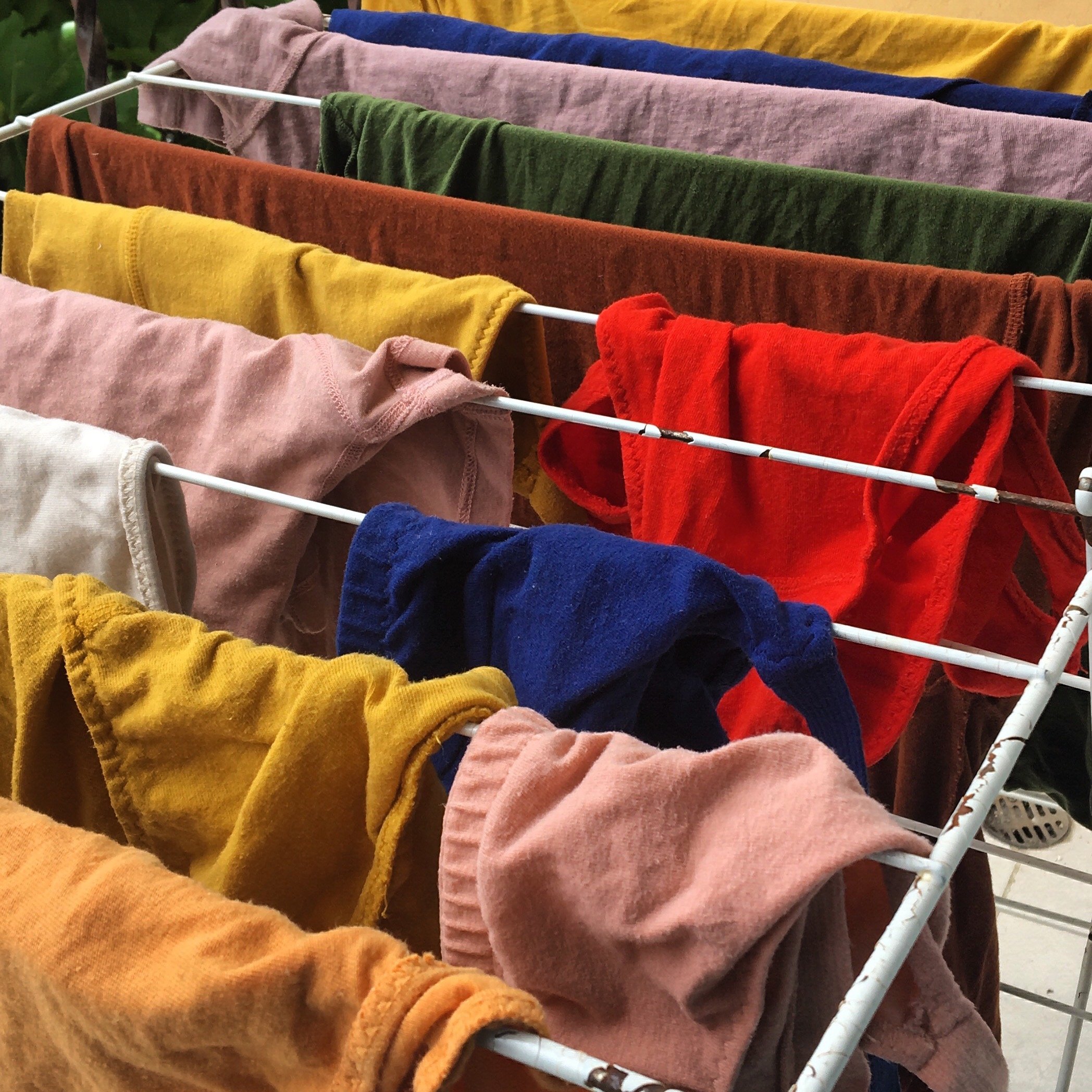 Colorful laundry hanging on a drying rack