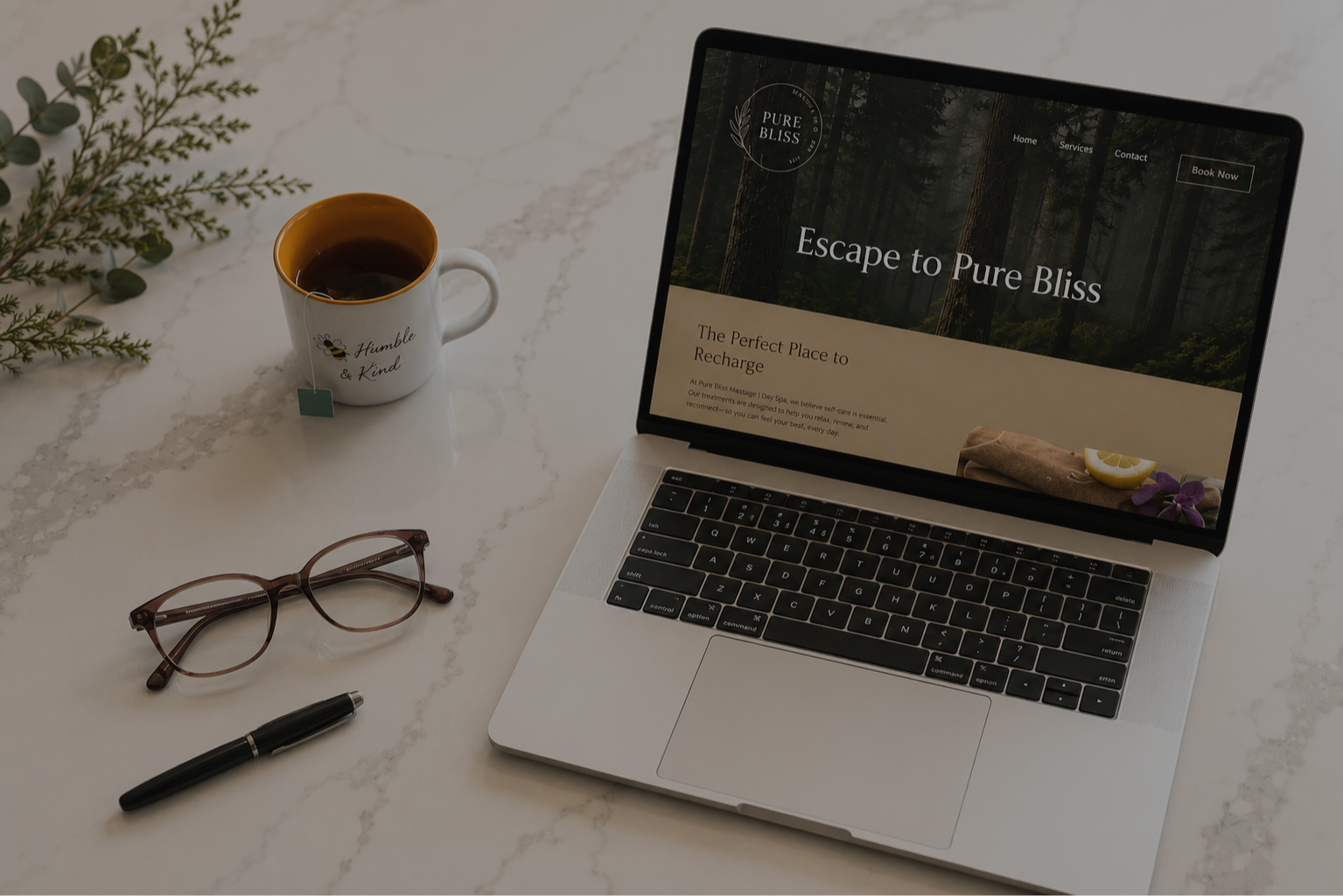 Pure Bliss Massage and Day Spa website displayed on a laptop.