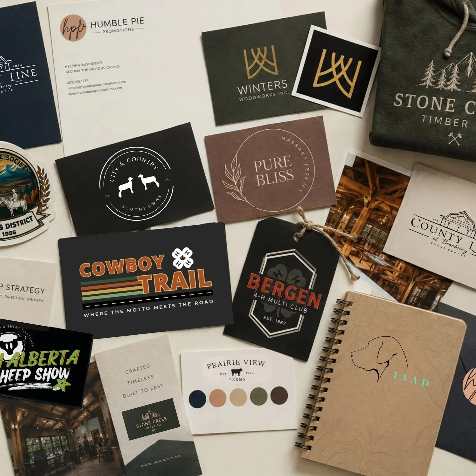 Collection of branded business cards, printed materials and notebooks created for local businesses.