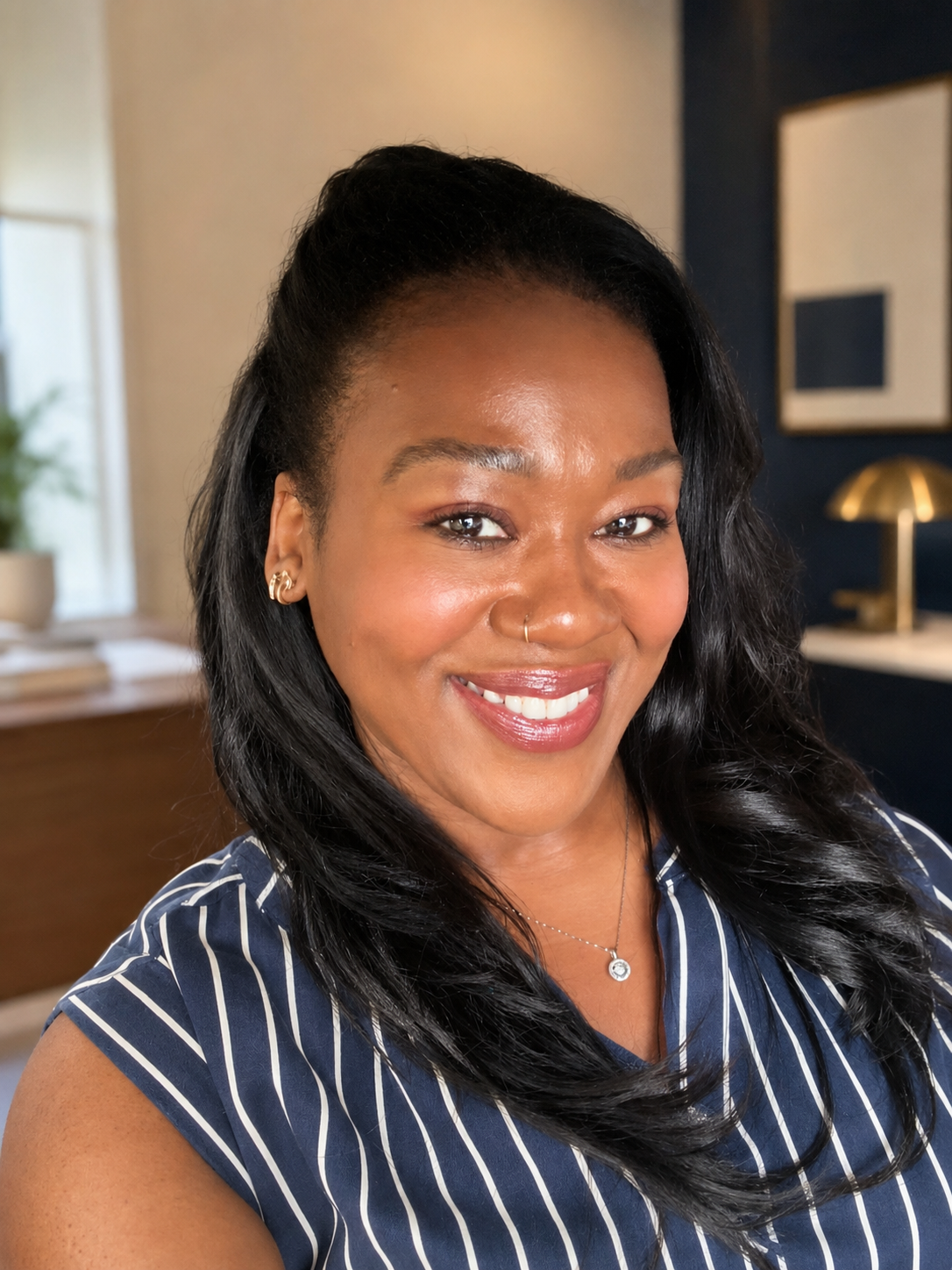 Latravia Banks-Gordon smiling in a bright office.