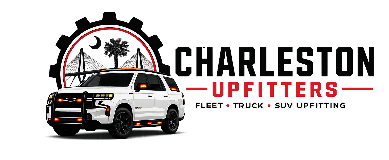 A white SUV with police-style lights and black rims, parked in front of a logo for Charleston UpFITTERS, featuring a moon, palm trees, and a tent, with text indicating they offer fleet truck and SUV upfitting services.