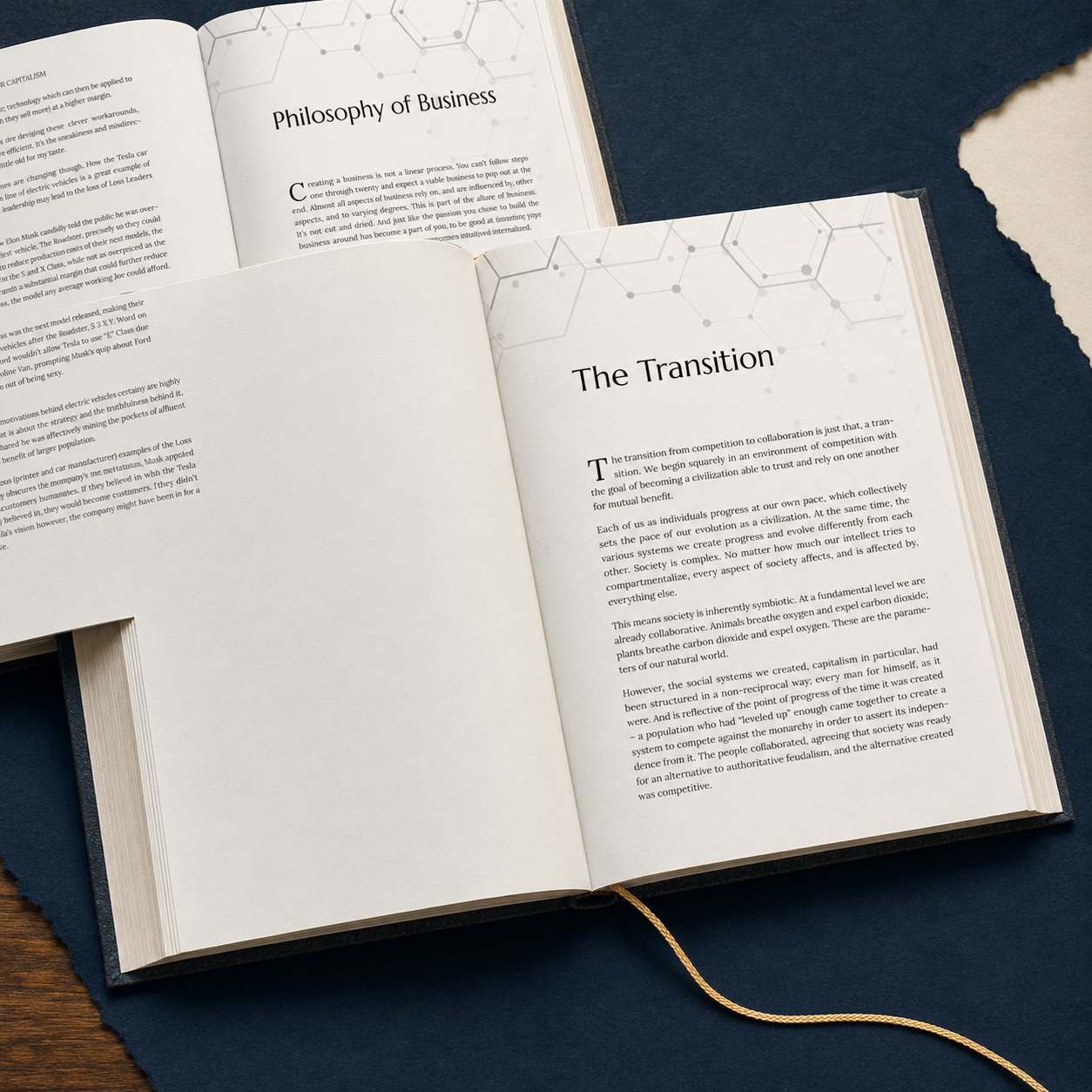 Open book with pages titled 'Philosophy of Business' and 'The Transition', resting on a dark cloth on a wooden surface.
