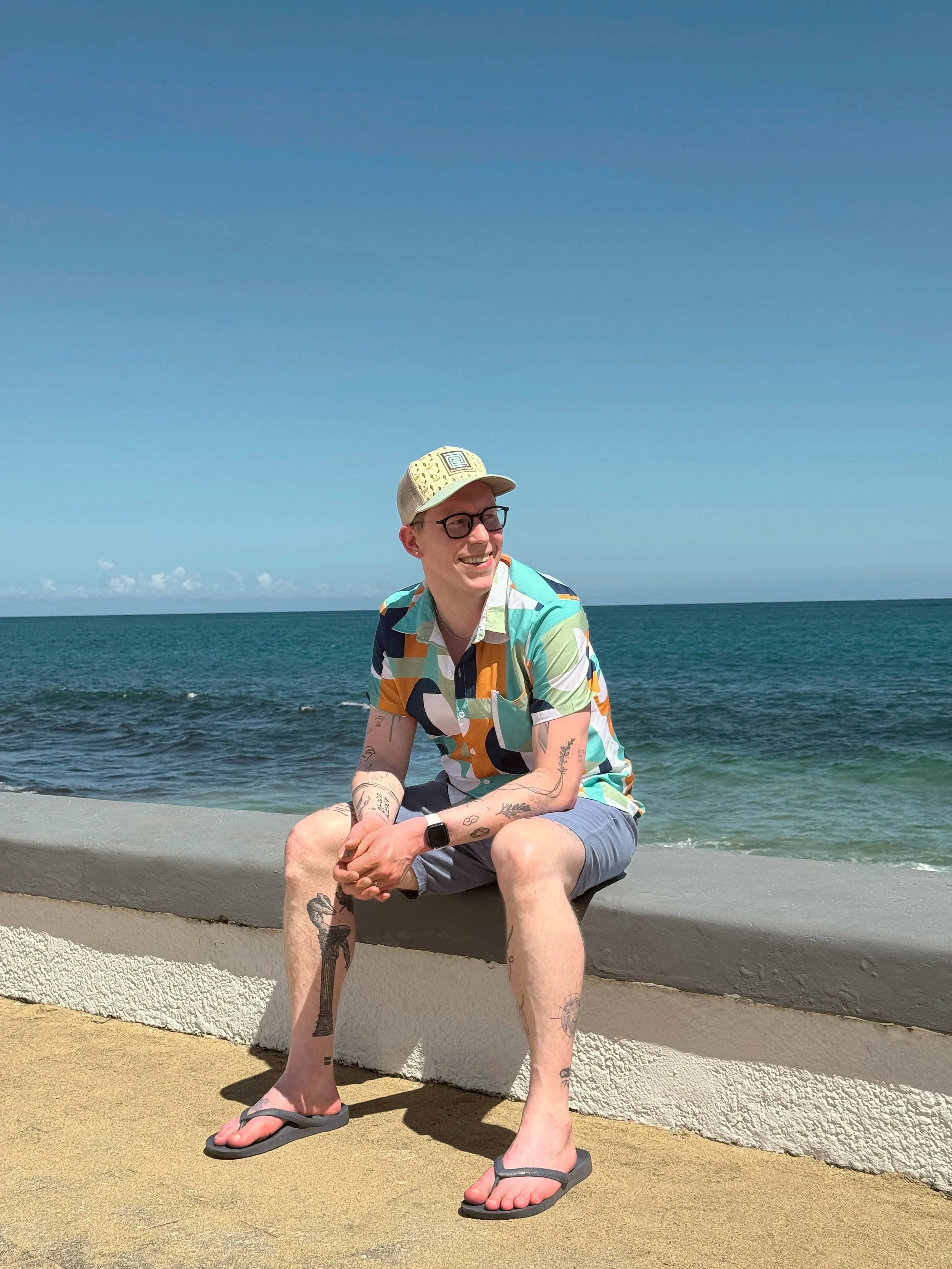 Cole Lemaster, founder of Finds You Well, sitting by the ocean