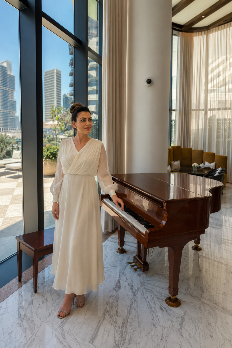 Professional pianist Kalina Simeonova beside a grand piano at a luxury venue in Dubai