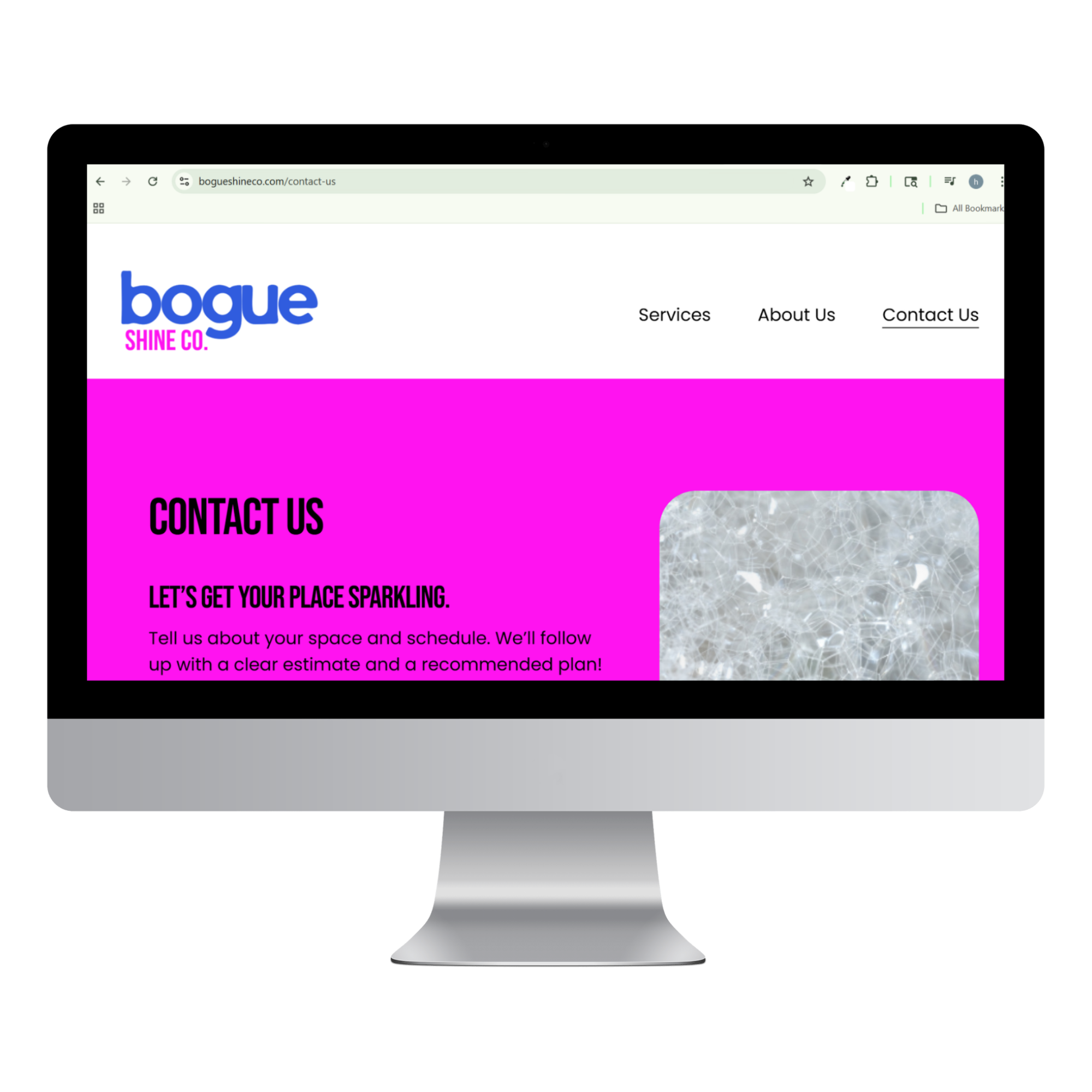 Computer monitor displaying a website for Bogue Shine Co., with navigation links 'Services', 'About Us', and 'Contact Us', and a pink and white background.