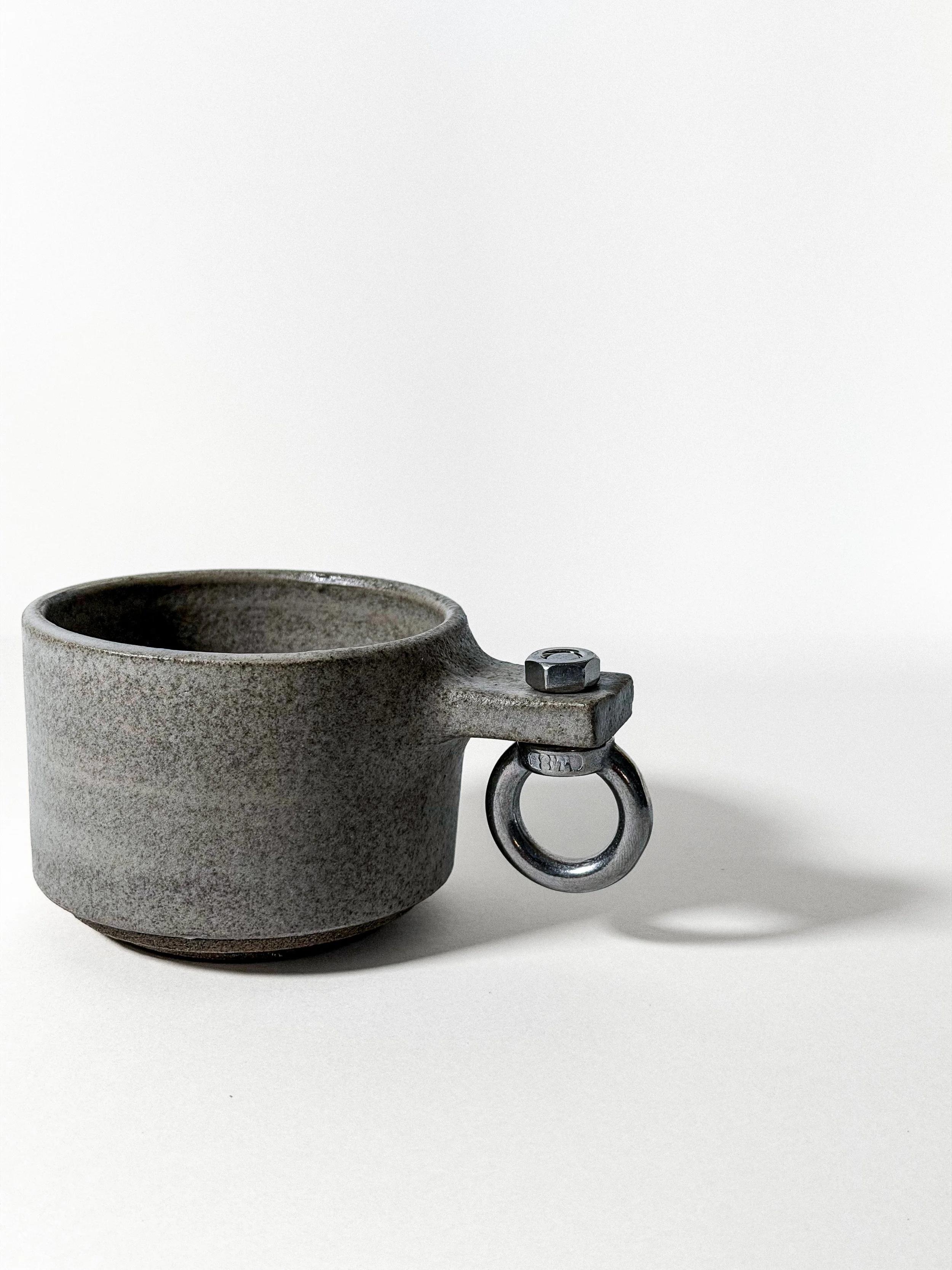 brutalist cup 01 loop close-up of speckled stoneware and steel eye-bolt handle with nut