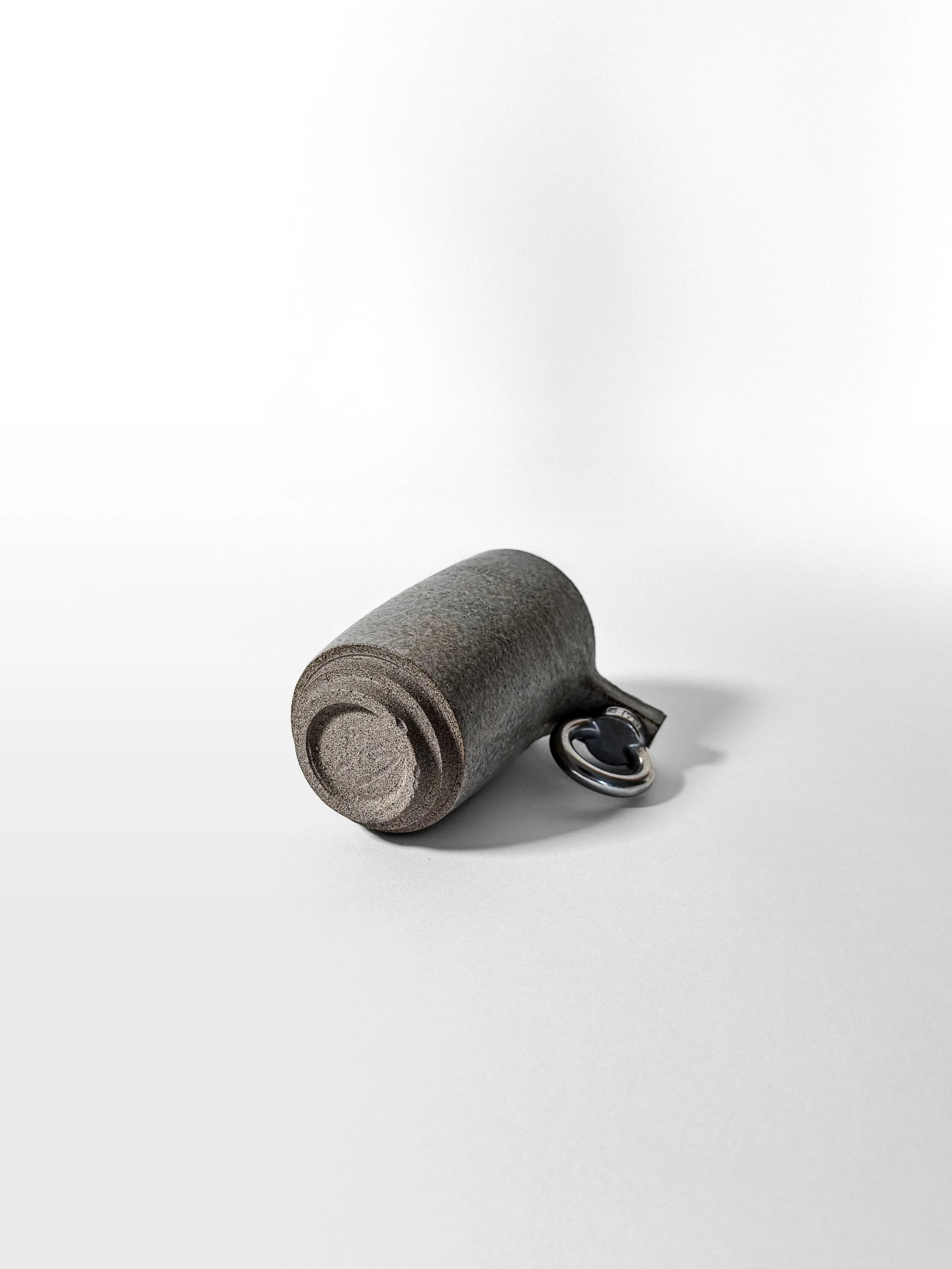 minibrut handmade espresso cup lying on its side, showing the eye-bolt handle