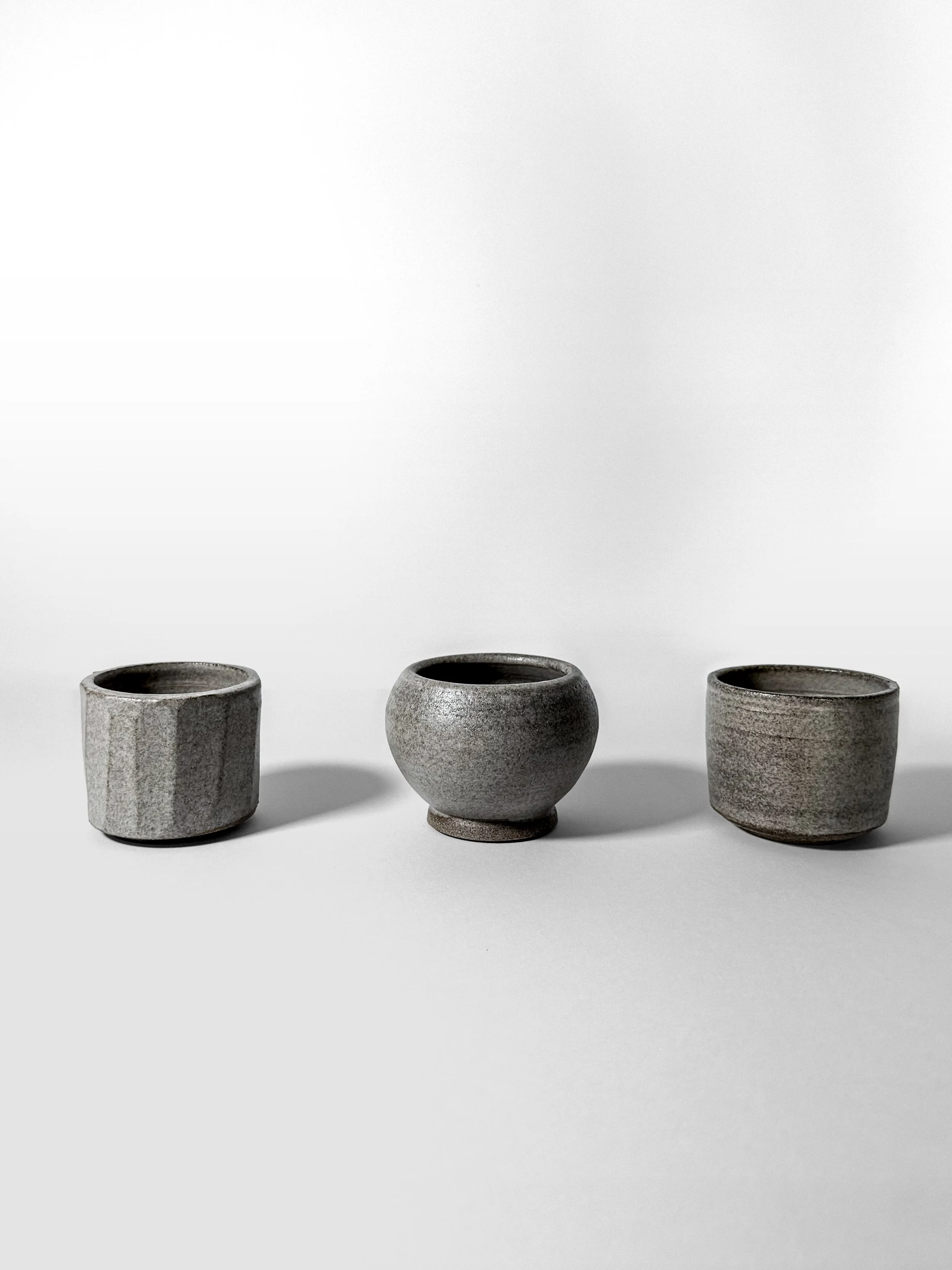espresso trio handmade stoneware cups in a row, side view