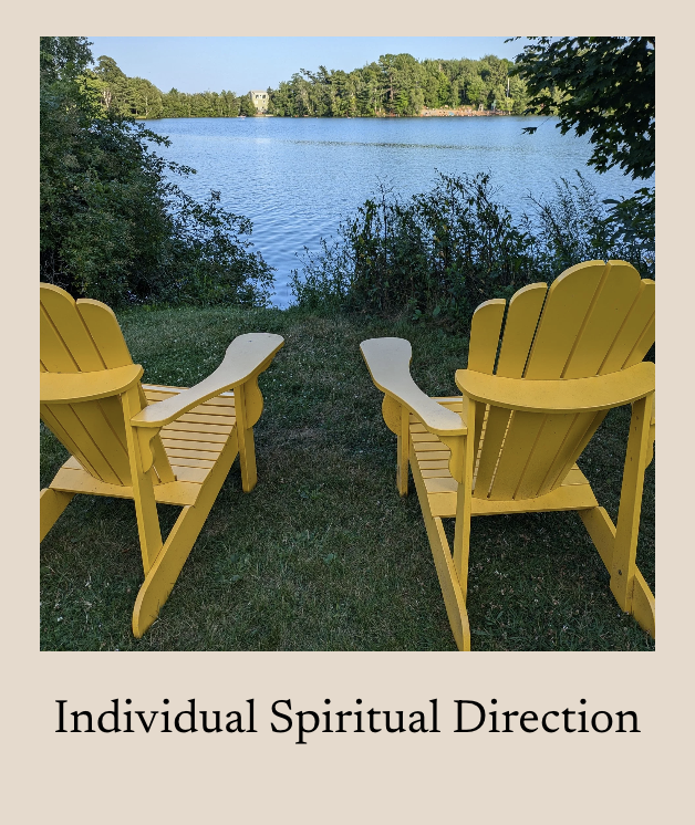 Two yellow Adirondack chairs facing a lake, surrounded by greenery, with trees and a building in the background, under a clear blue sky.