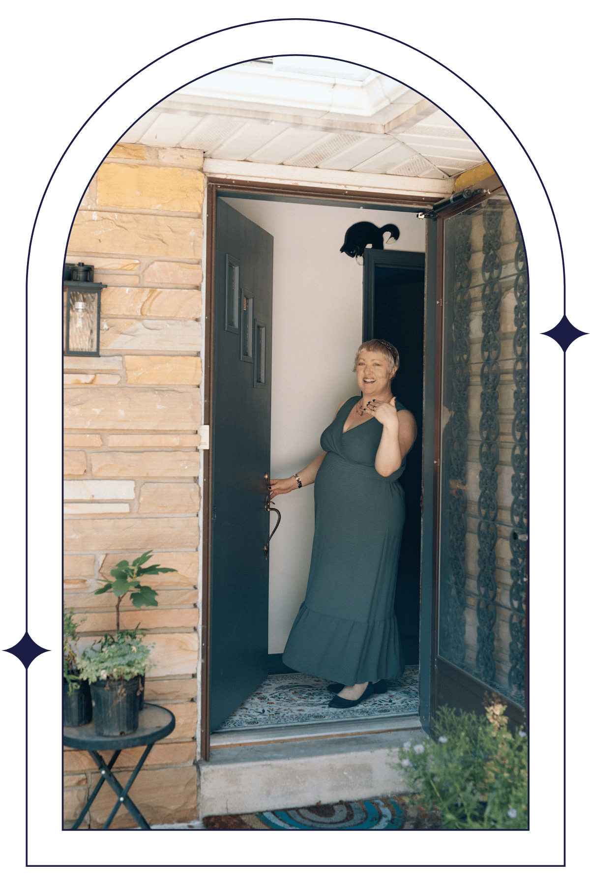 Omy Golden smiling and welcoming clients at the door of Dark Moon Counseling