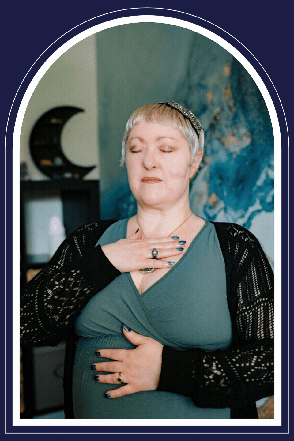 Omy Golden, licensed professional counselor, practicing mindful breathing with her hands on her chest and stomach before stretching her arms overhead with a playful expression.
