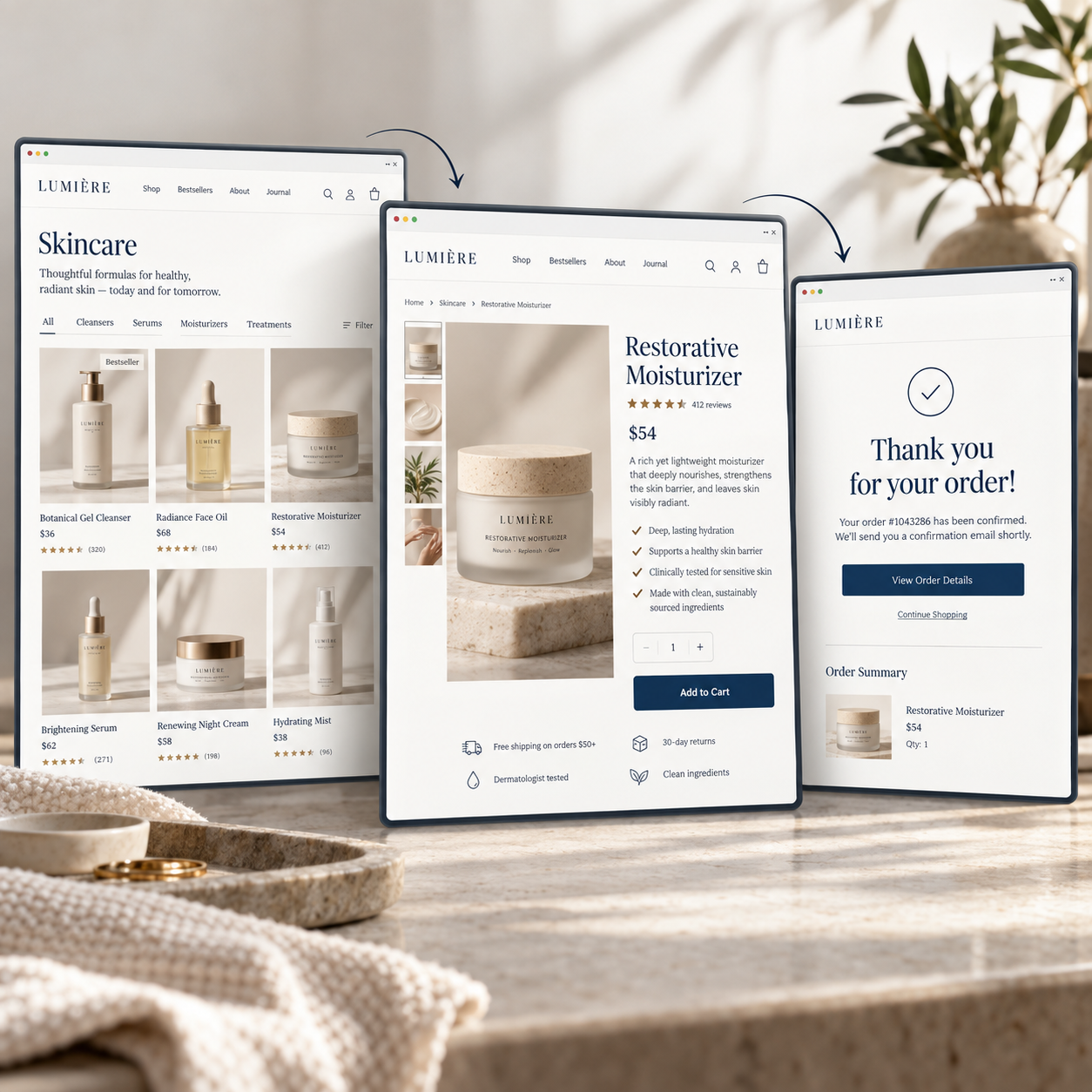 Digital screens displaying an online skincare store, showing product listings, a detailed product page for restorative moisturizer, and a confirmation message for a recent order, set on a marble countertop with a plant in the background.