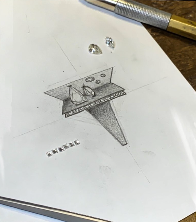 A pencil sketch of a sailboat on a table, with two small gemstones above it and some decorative stones below.