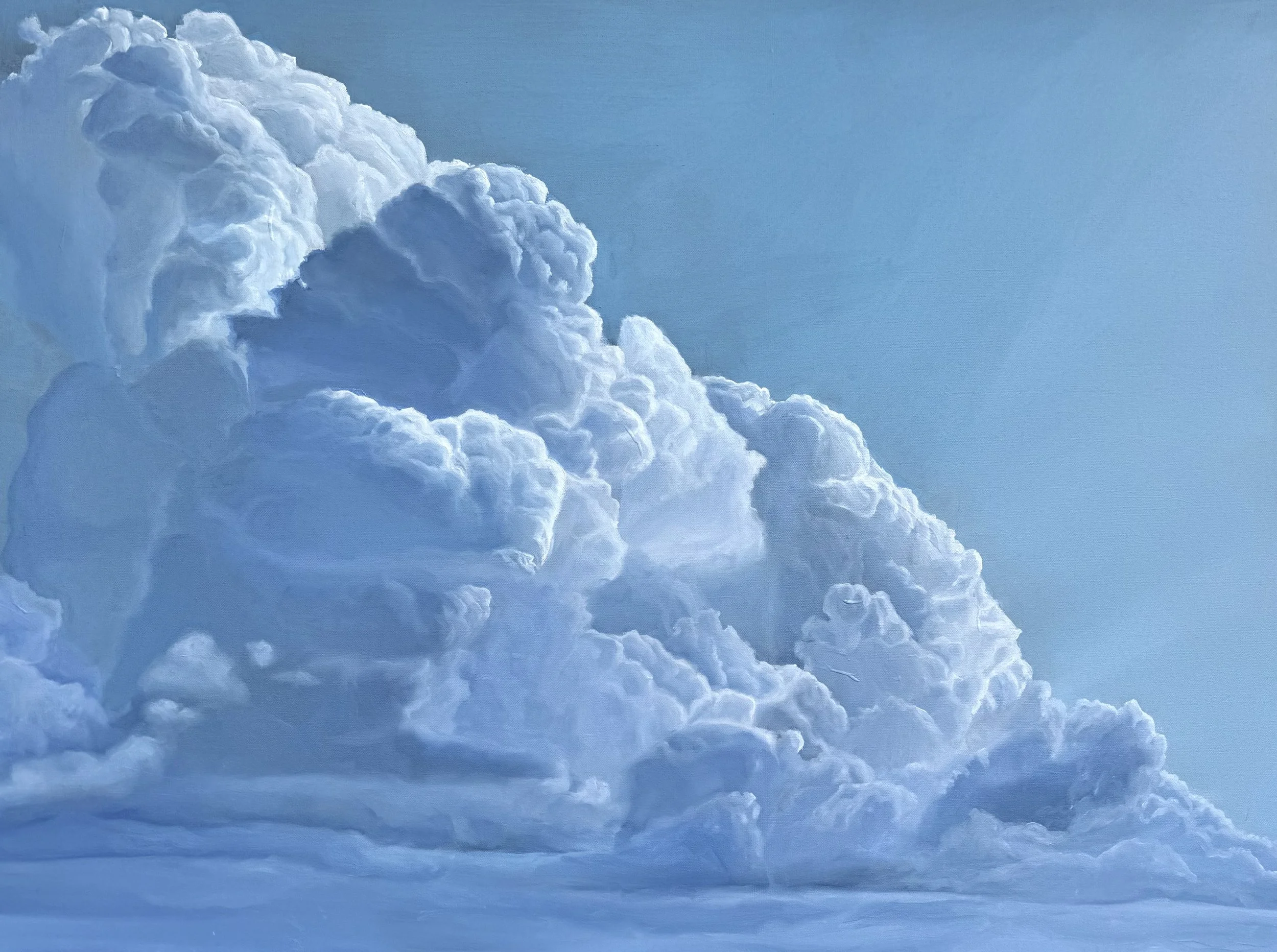 A photograph of fluffy white clouds against a clear blue sky.