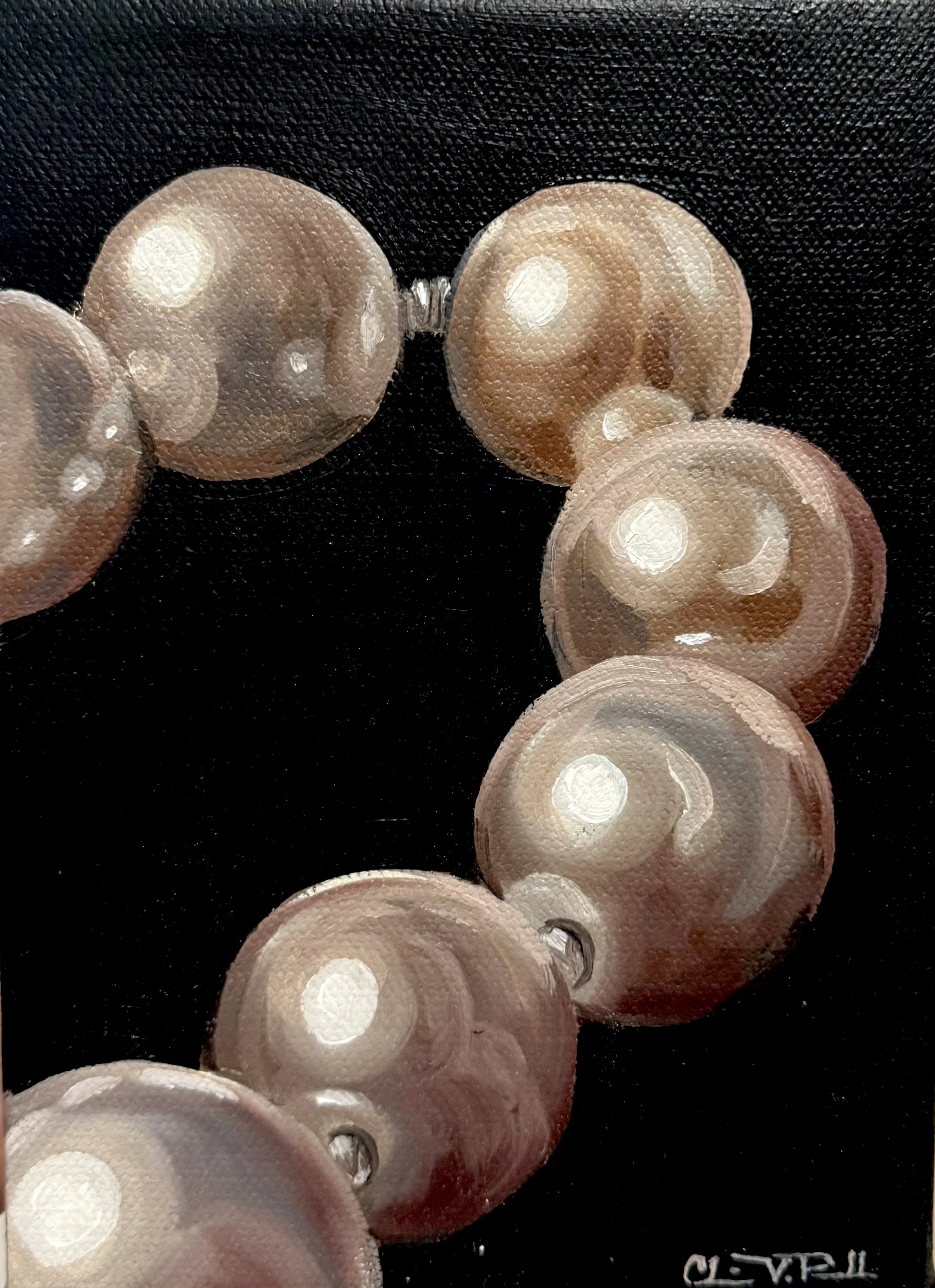 Close-up view of several plastic buttons with circular indentations, arranged on a black textured surface.