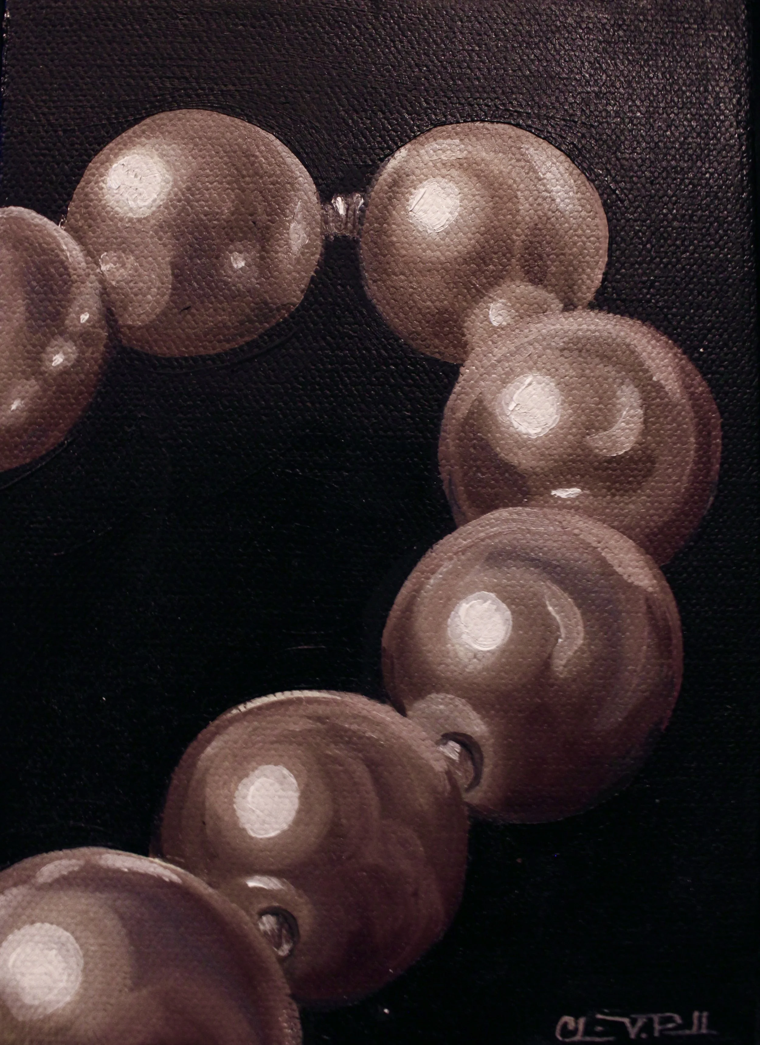 Close-up of several brown eyeshadow pans with different shades, arranged on a black background.