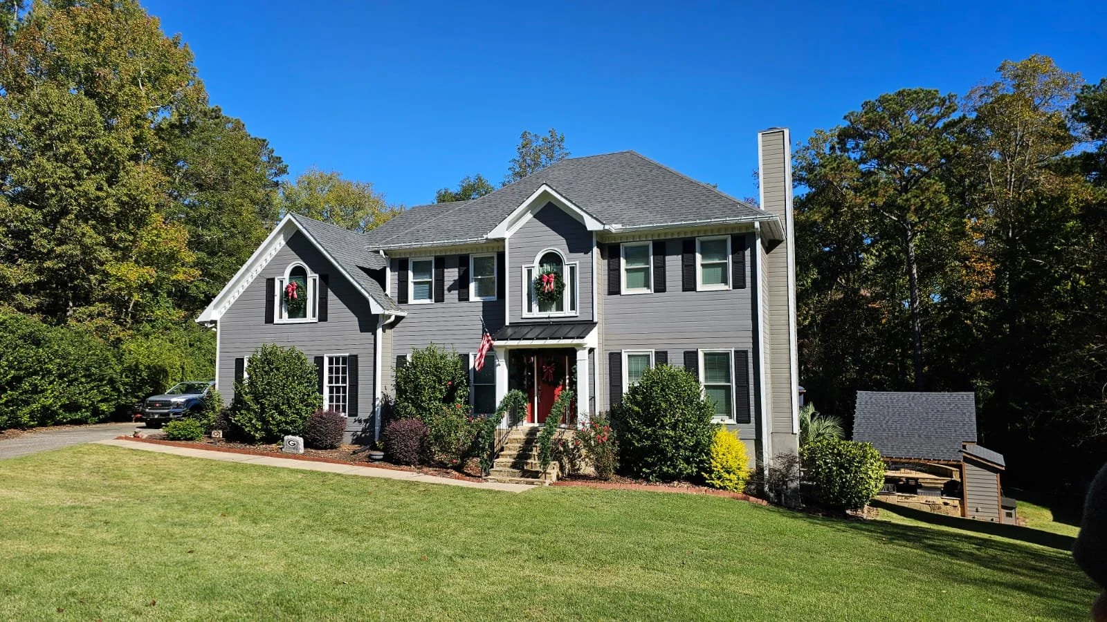 Professional holiday lighting setup on two-story home in Greensboro, GA.