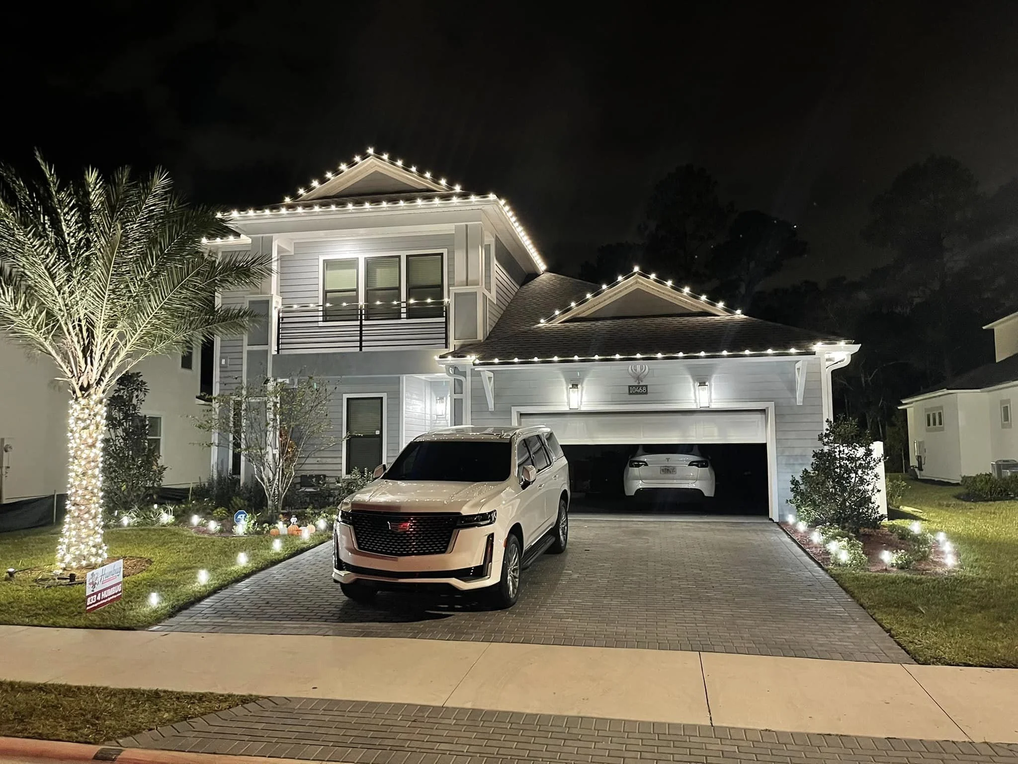 Commercial-grade holiday light installation on a two-story home in Milledgeville, GA.