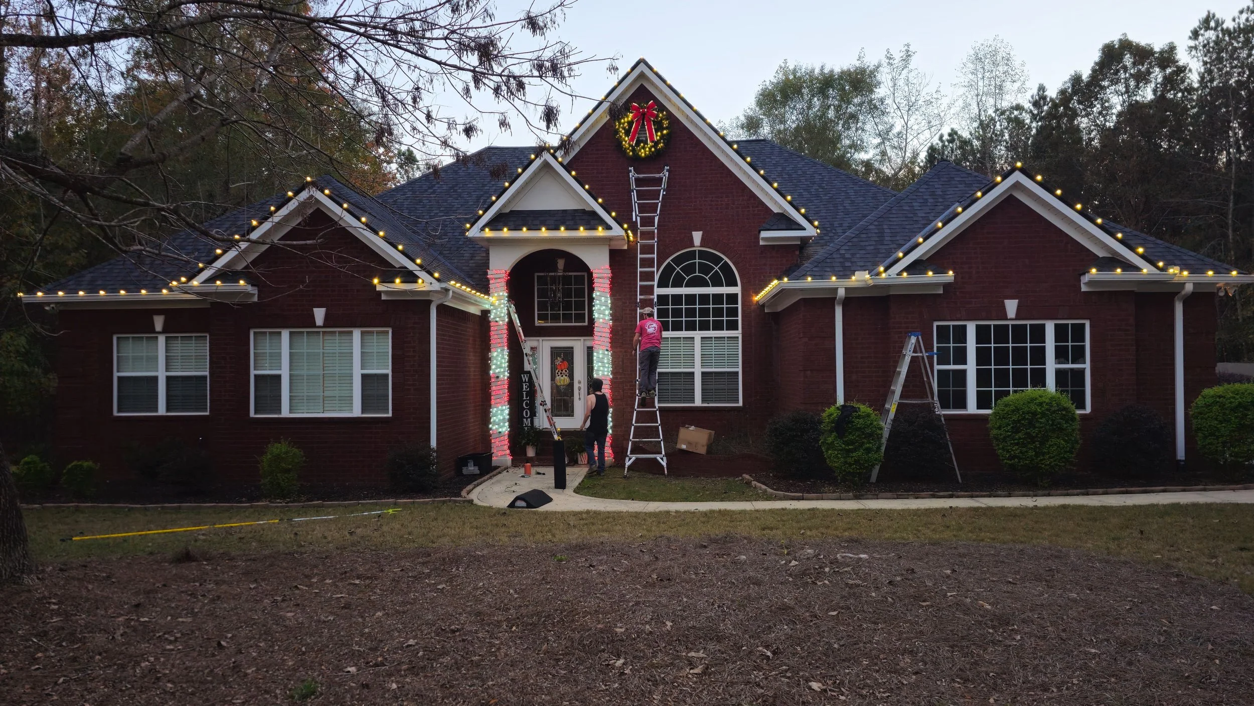 Custom cascading light curtains and outdoor holiday decor on a Greensboro estate.