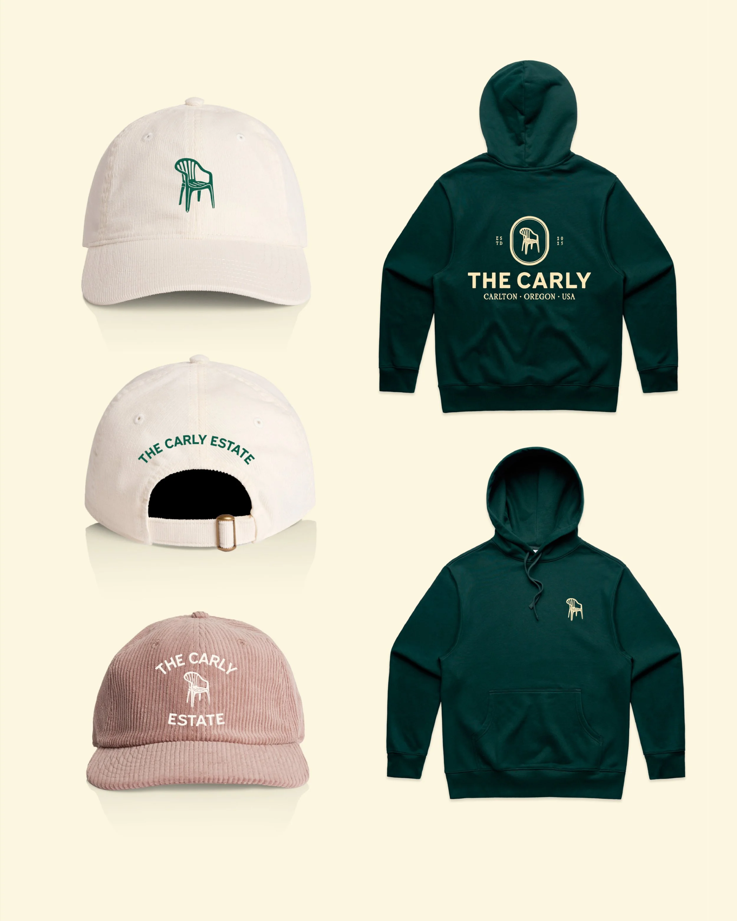 A collection of clothing items including a white baseball cap with green embroidery of a chair, a pink beanie with white embroidery of a chair, a white baseball cap with green embroidery, a dark green hoodie with white logo and text "The Carly," and a black hoodie with a small logo on the chest. All items are arranged against a light beige background.