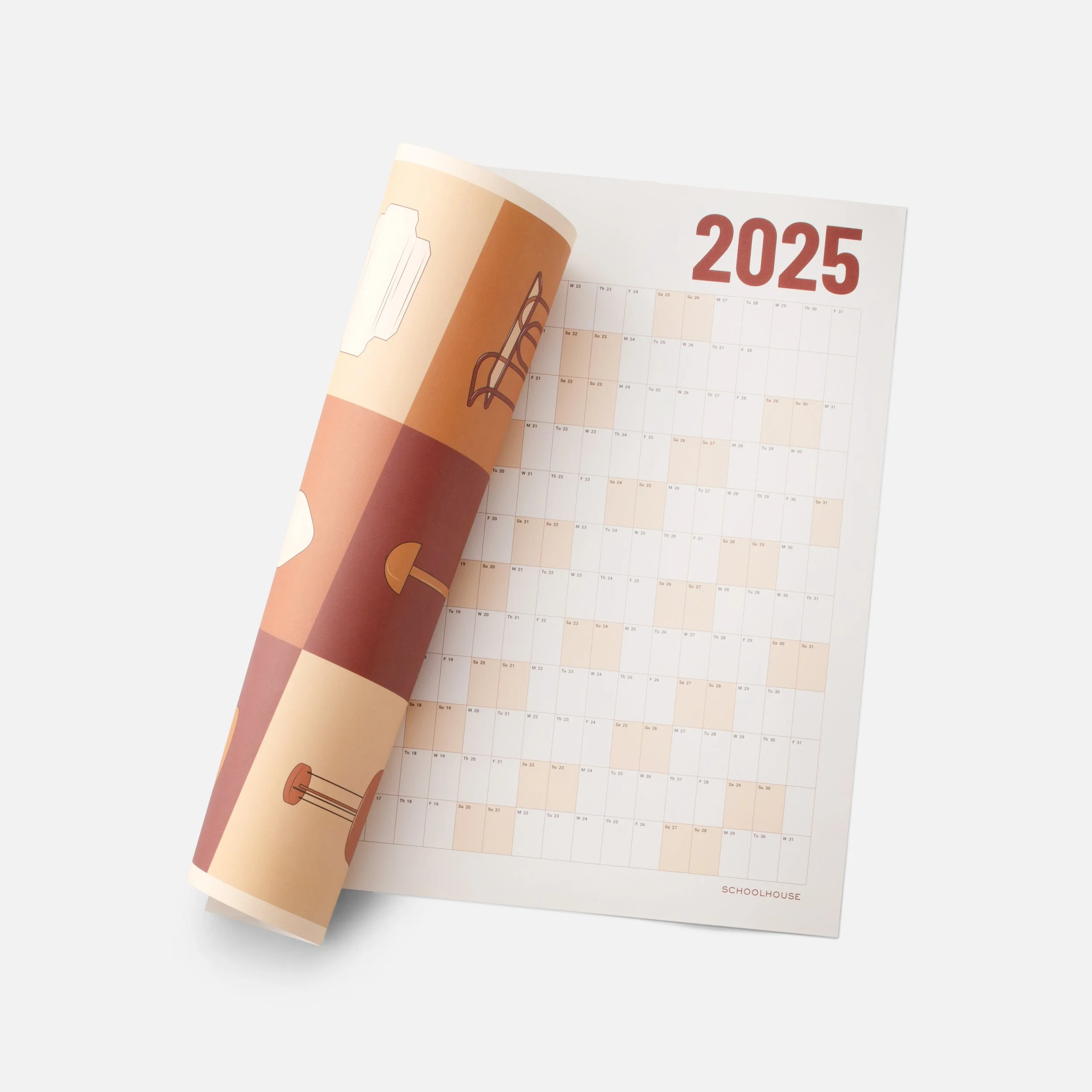 A paper calendar showing the year 2025, with part of it turned to reveal a logo of a schoolhouse. The calendar displays dates in a grid format with days of the week and months.