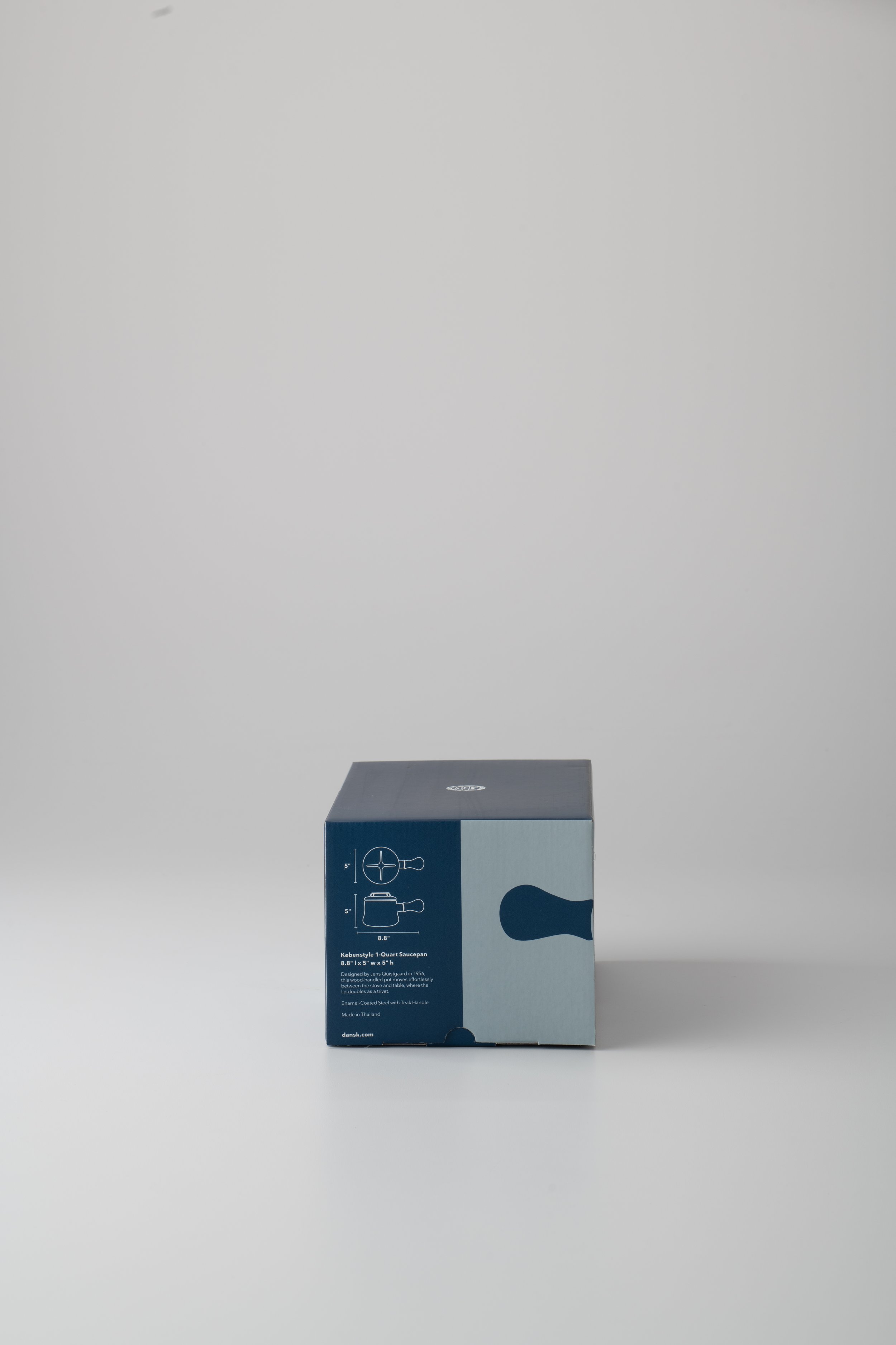 A boxed kitchen utensil with a blue and white design and illustrations, set against a plain white background.