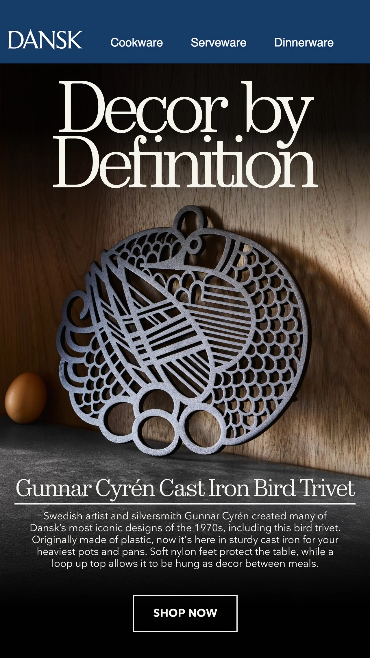 A webpage about Dansk decor, featuring a wooden background, a decorative cast iron bird trivet, and a single egg. The page highlights Gunnar Cyren, a Swedish artist and silversmith, and includes a 'Shop Now' button.