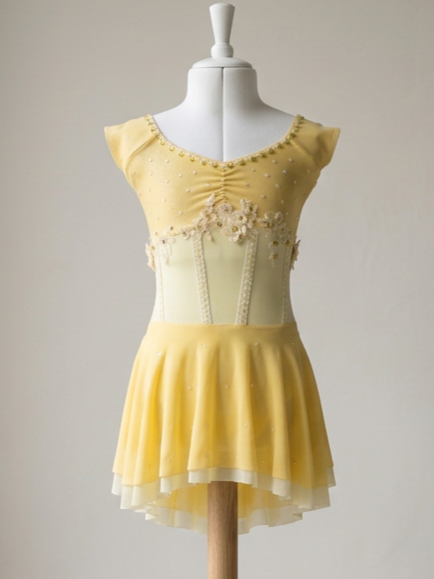 Yellow dress on a mannequin with decorative details and floral accents.