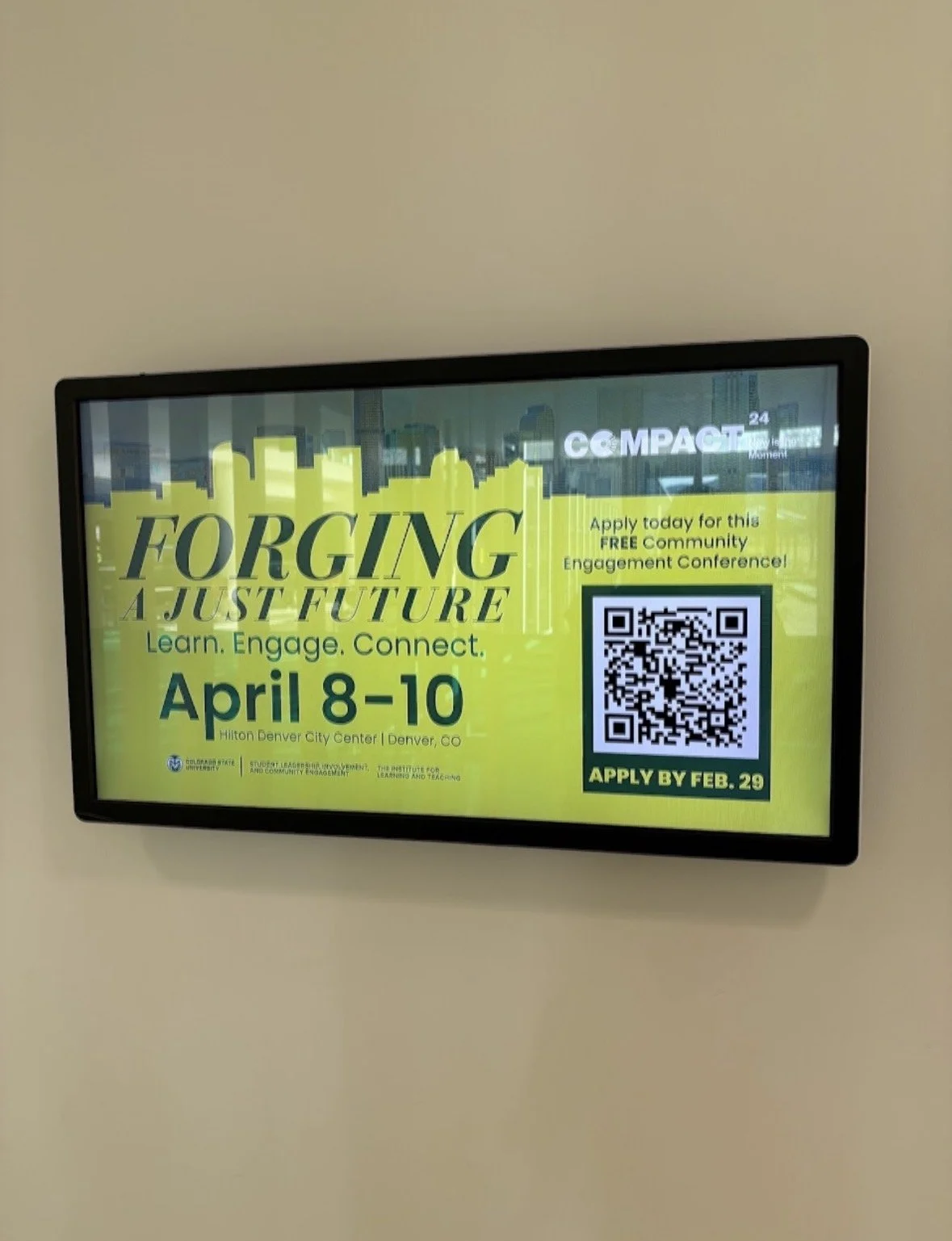 Digital advertisement for a community engagement conference titled 'Forging a Just Future' happening April 8-10 at Hilton Denver City Center, Colorado. Features QR code to apply by February 29.