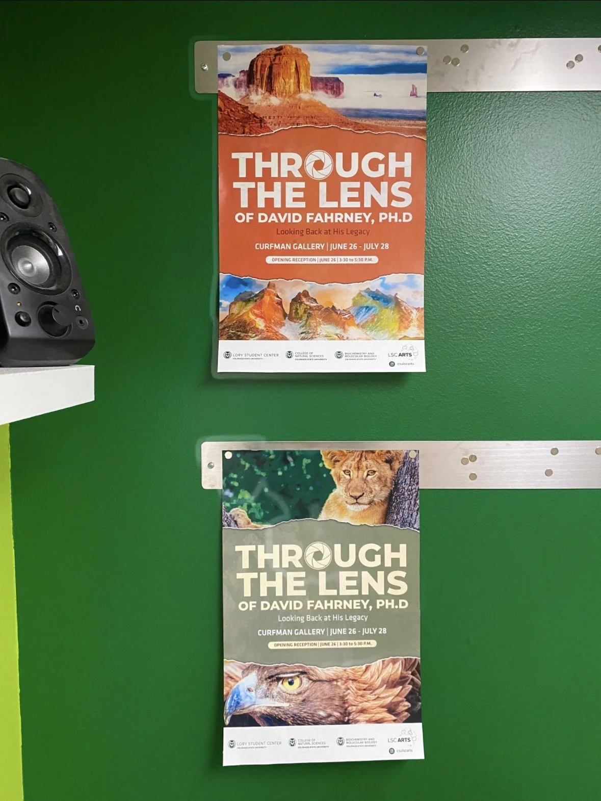 Two posters promoting the exhibition 'Through the Lens of David Fahrney, Ph.D.' at the Curfman Gallery from June 26 to July 28. The posters feature nature and animal images.