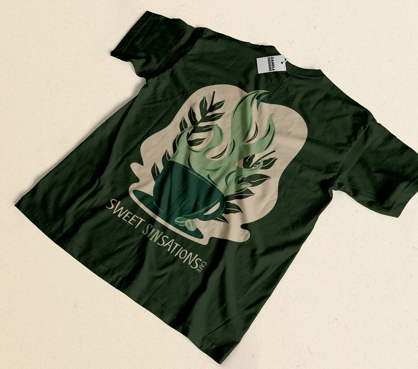 Black T-shirt featuring a large graphic of a steaming coffee cup with coffee beans, surrounded by green and beige foliage. Text on shirt reads "SWEET SINSATIONS."