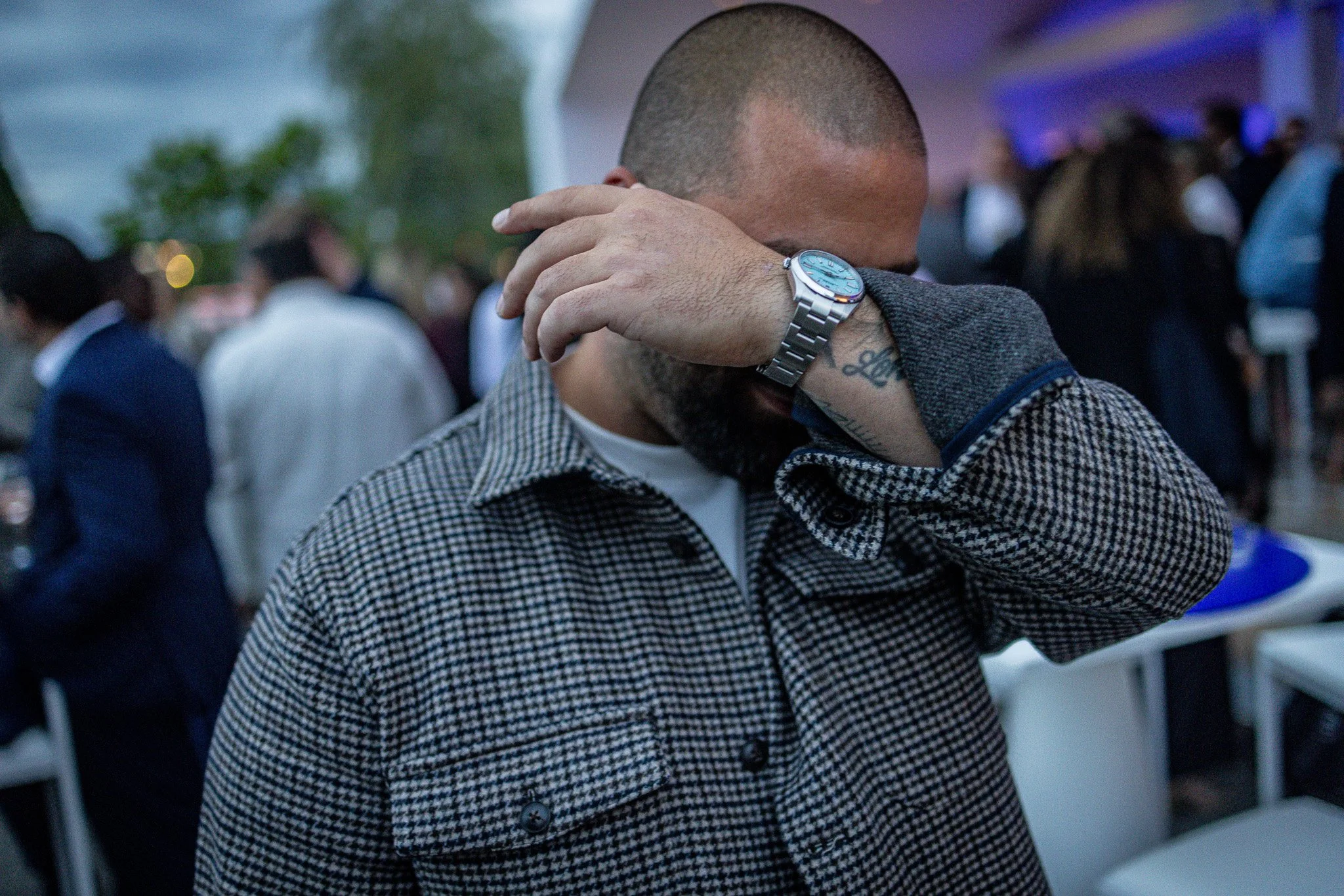 A man with a bald head and tattoos on his arm and a Rolex Oyster Perpetual at Geneva Watch Days