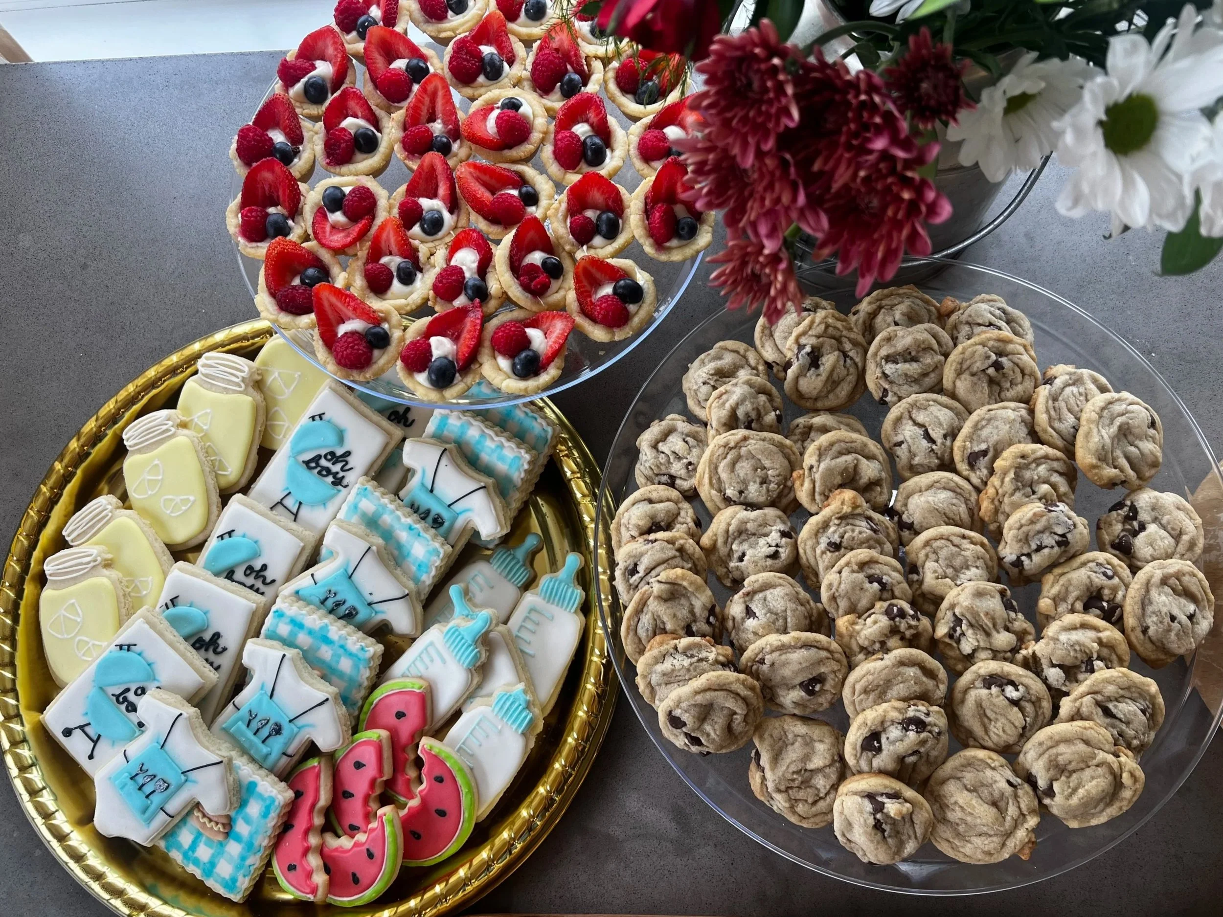Tray of decorated cookies with rainbow, pink flamingo, and